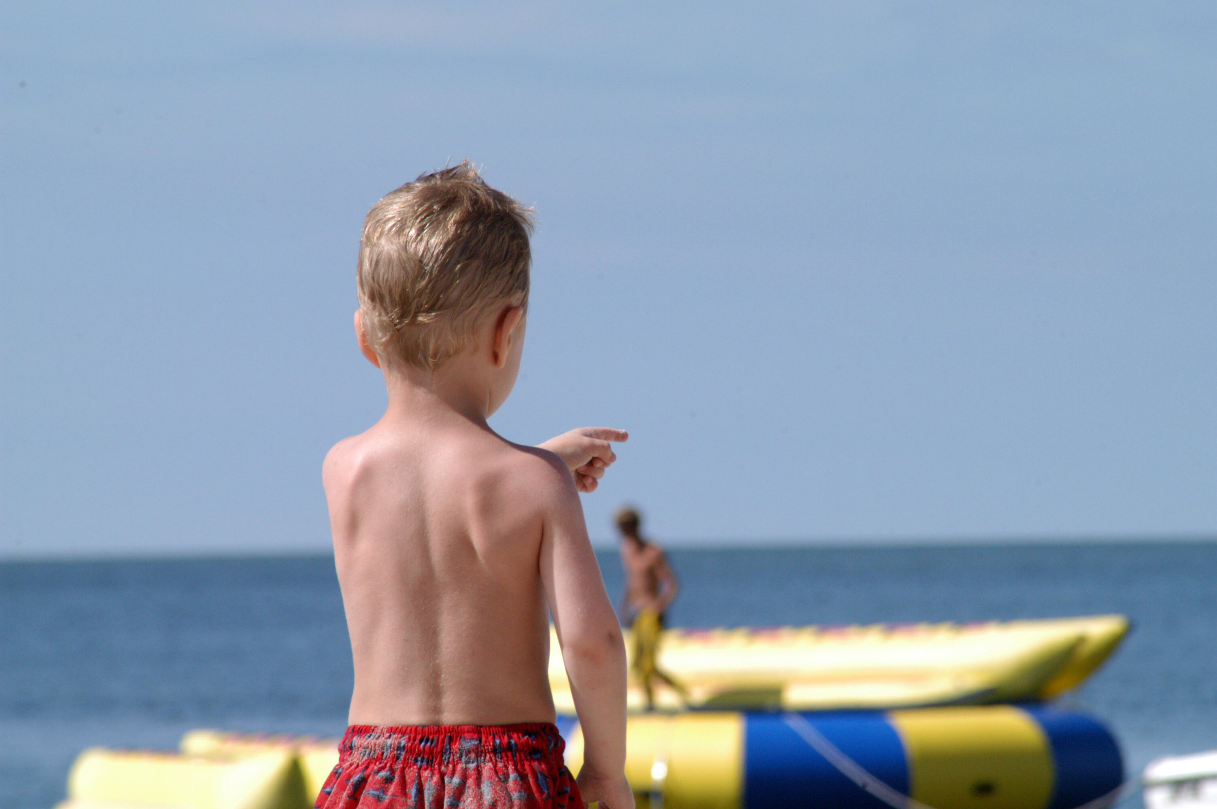 A pointing boy on the beach.jpg