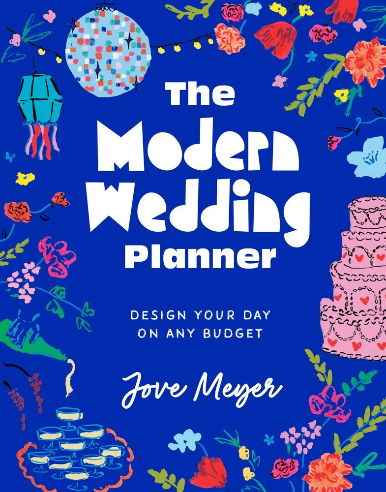 Cover of a wedding planner book titled 'The Modern Wedding Planner' with colorful flowers, a cake, a lantern, and a string of lights on a dark blue background.