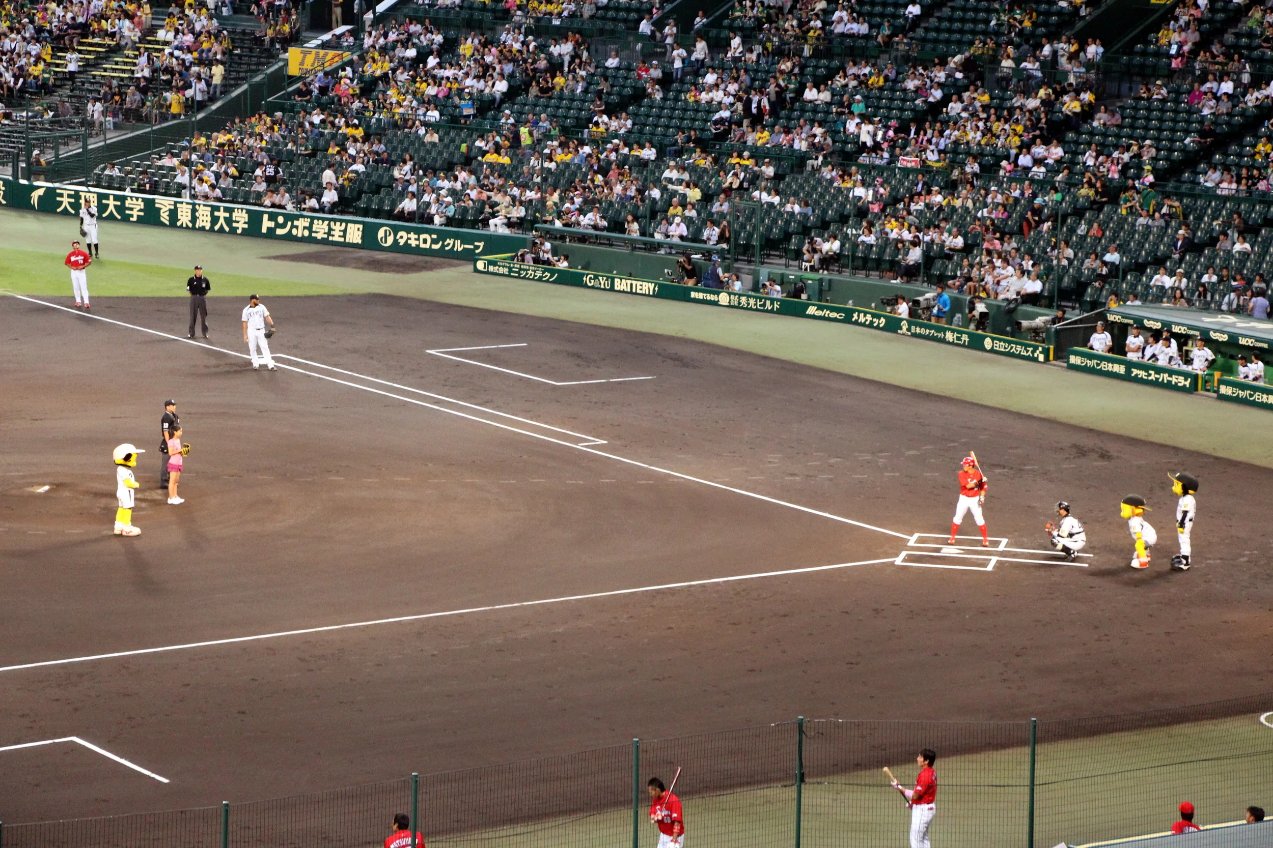 In the second ceremonial first pitch, this young girl throws a loopy pitch that the Carp players swings at and missed badly.