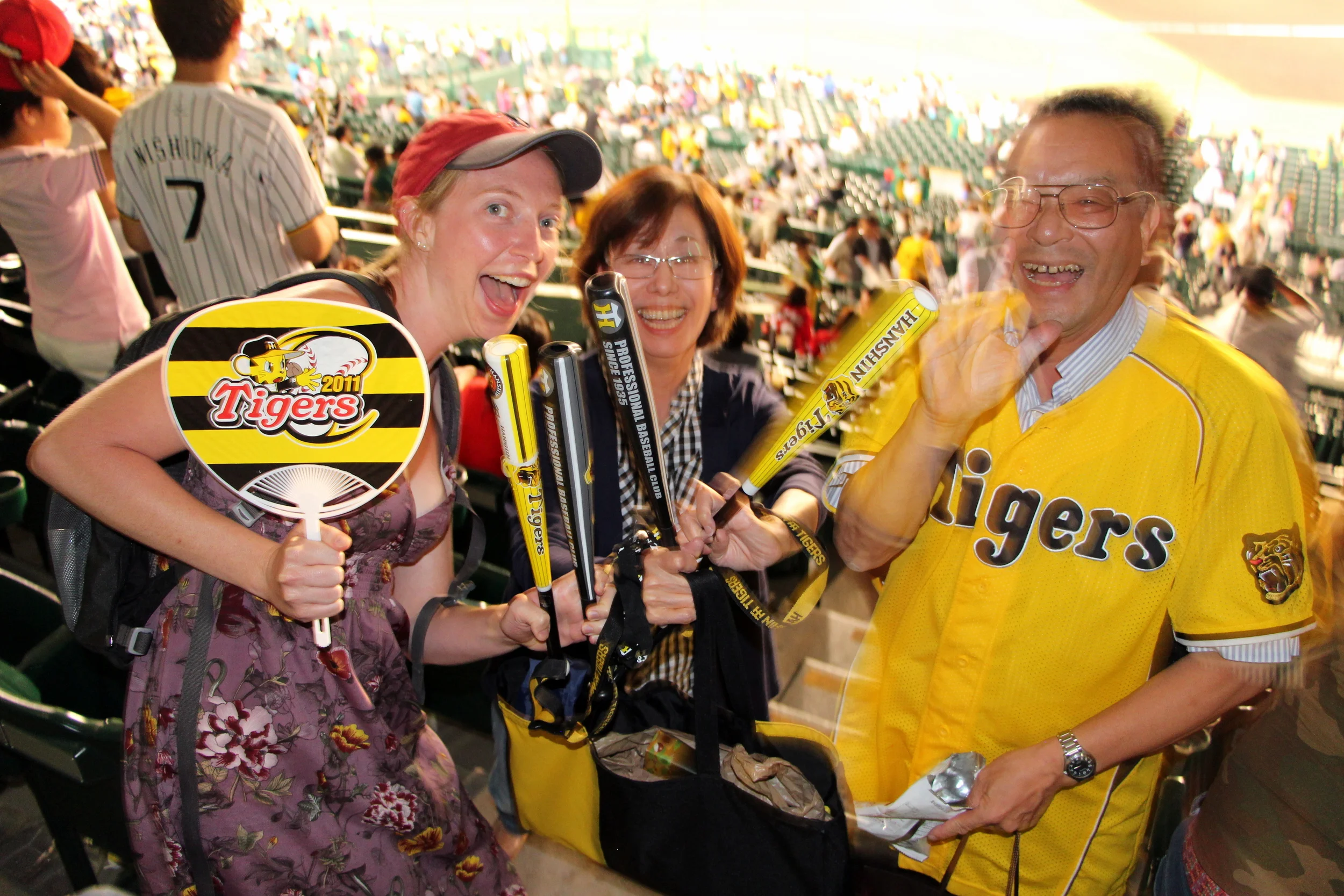 Kelsi with enthusiastic Tigers fans. The woman saw her cheering at the end of the game and actually came up to her to give her the fan, which she got from a game in 2011, as a gift.