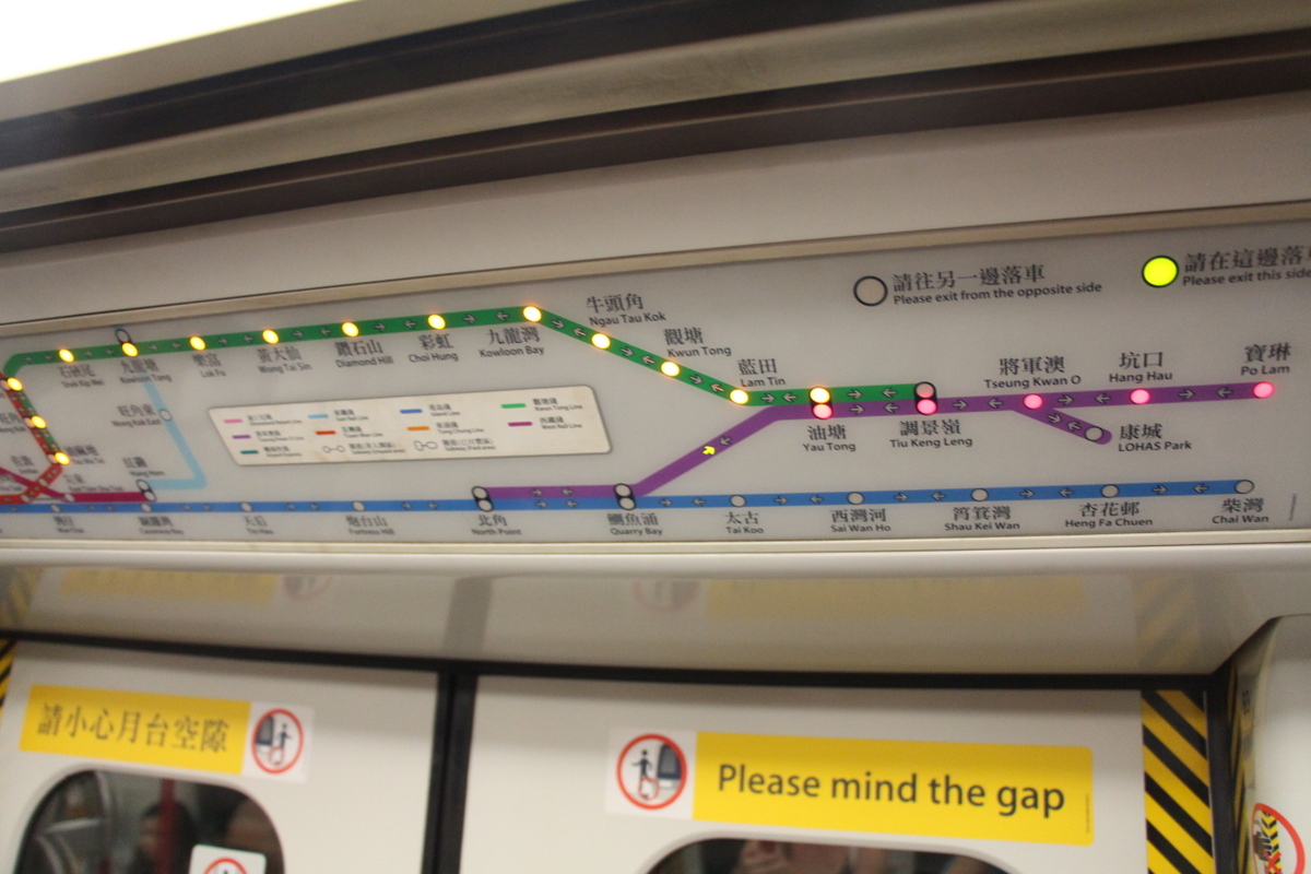This purple line train is approaching a station with a green line interchange. The lights on the map highlight the upcoming stops on this purple train as well as the stops on the green line train that will be directly across the platform at the next station.