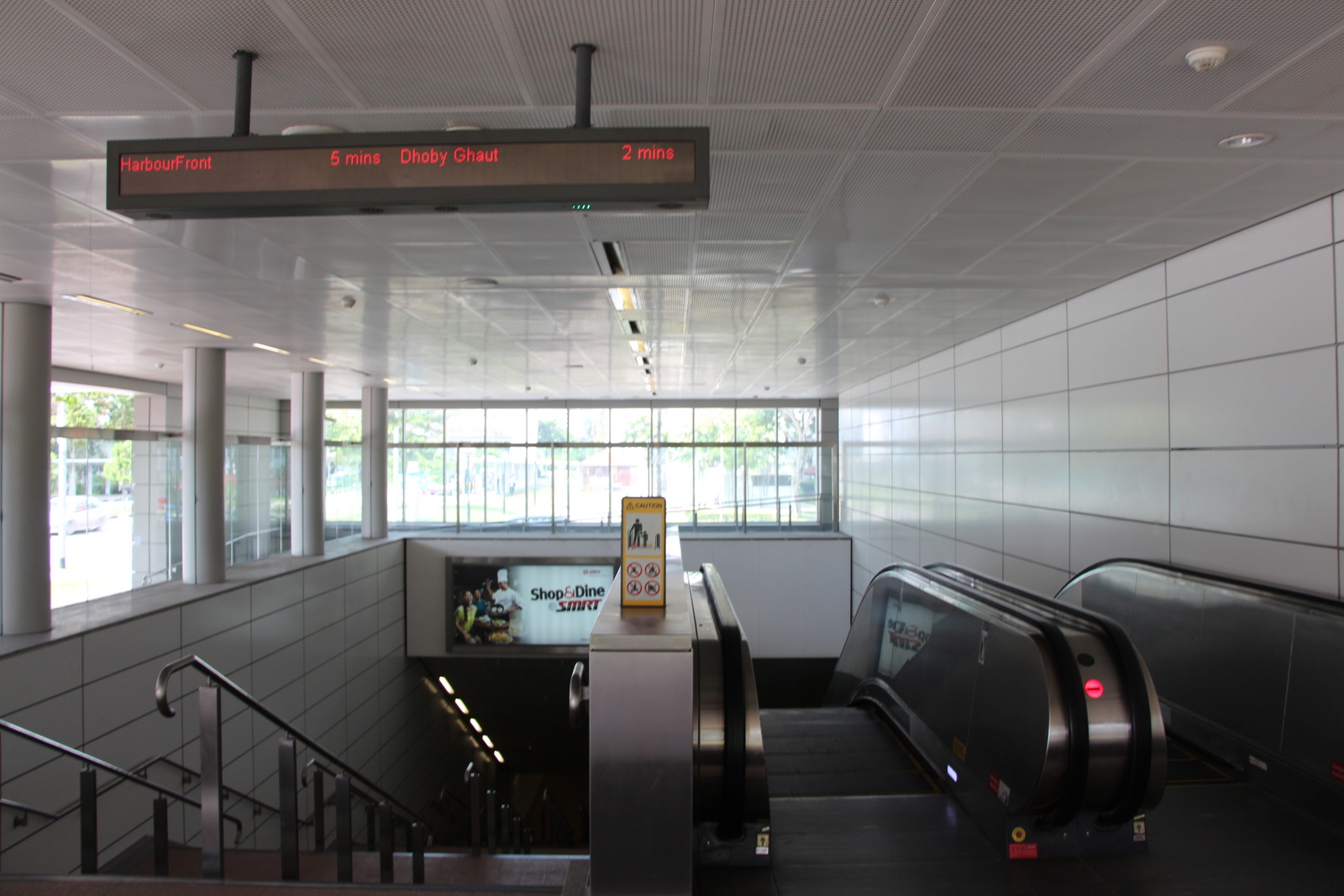 By showing a train countdown timer outside of a station (the sign in the upper left of this photo), riders know if a train will be arriving shortly or if there is no need to hurry into the station as they will be waiting for several minutes.