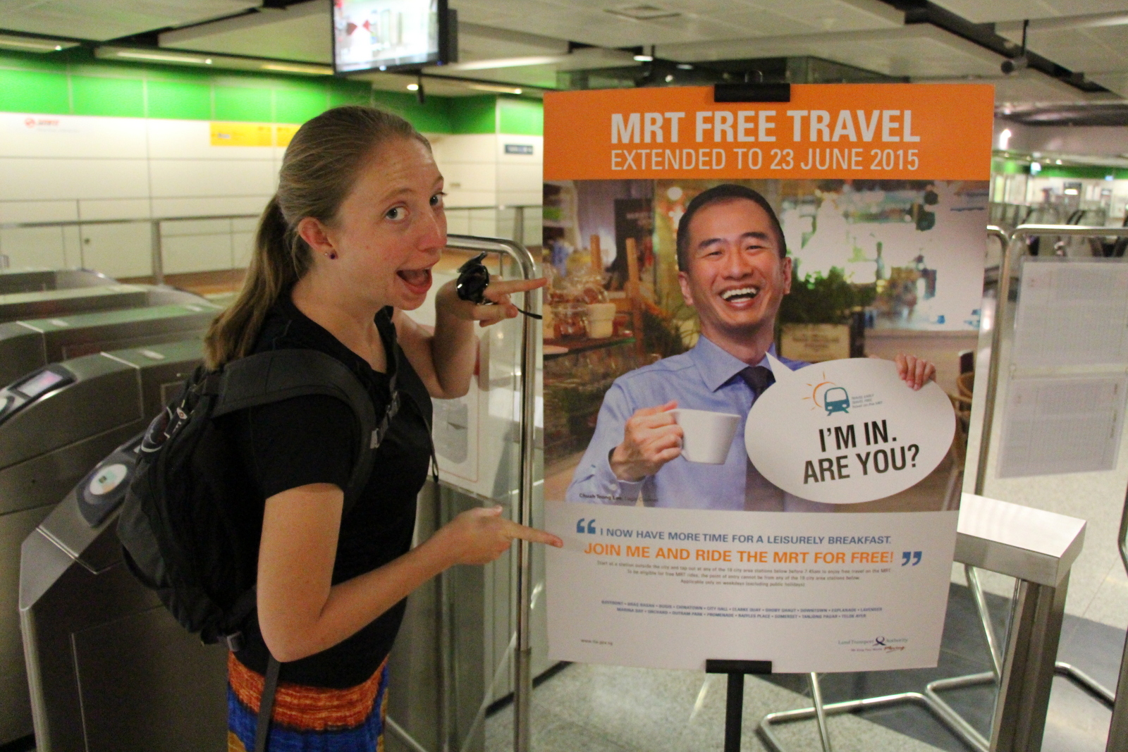 Kelsi reads the sign explaining the free metro ride program for early commuters