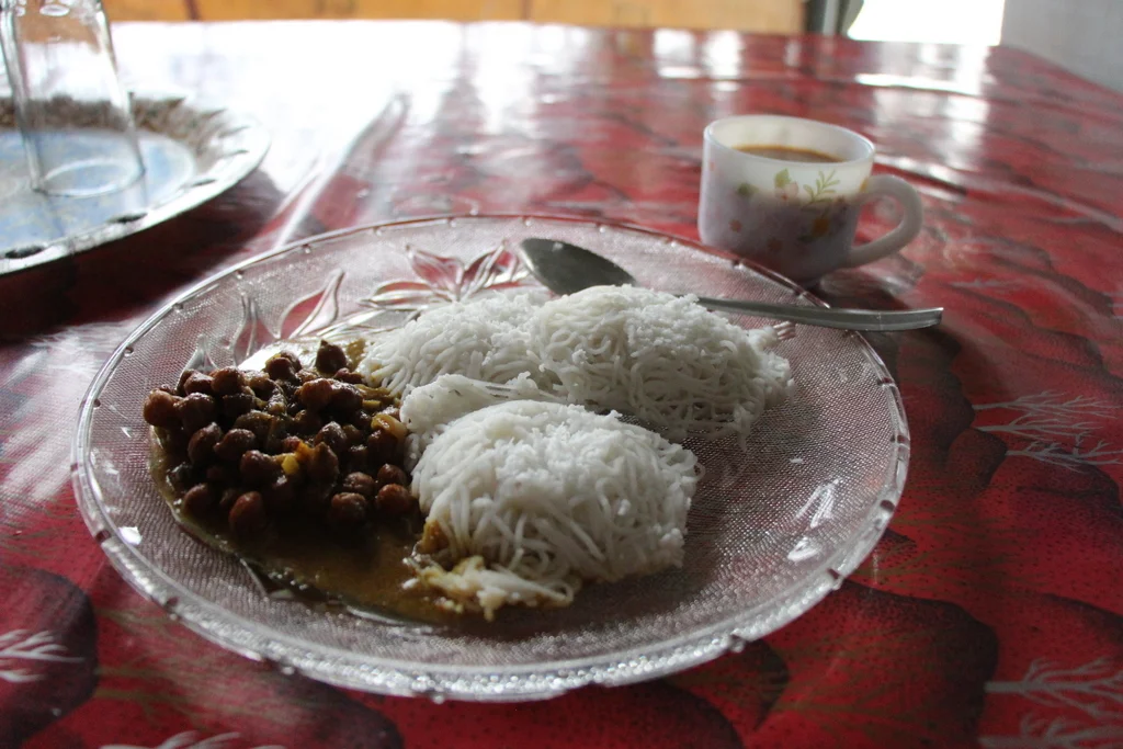 Chickpeas, string hoppers, and masala chai for breakfast in Alleppey. 