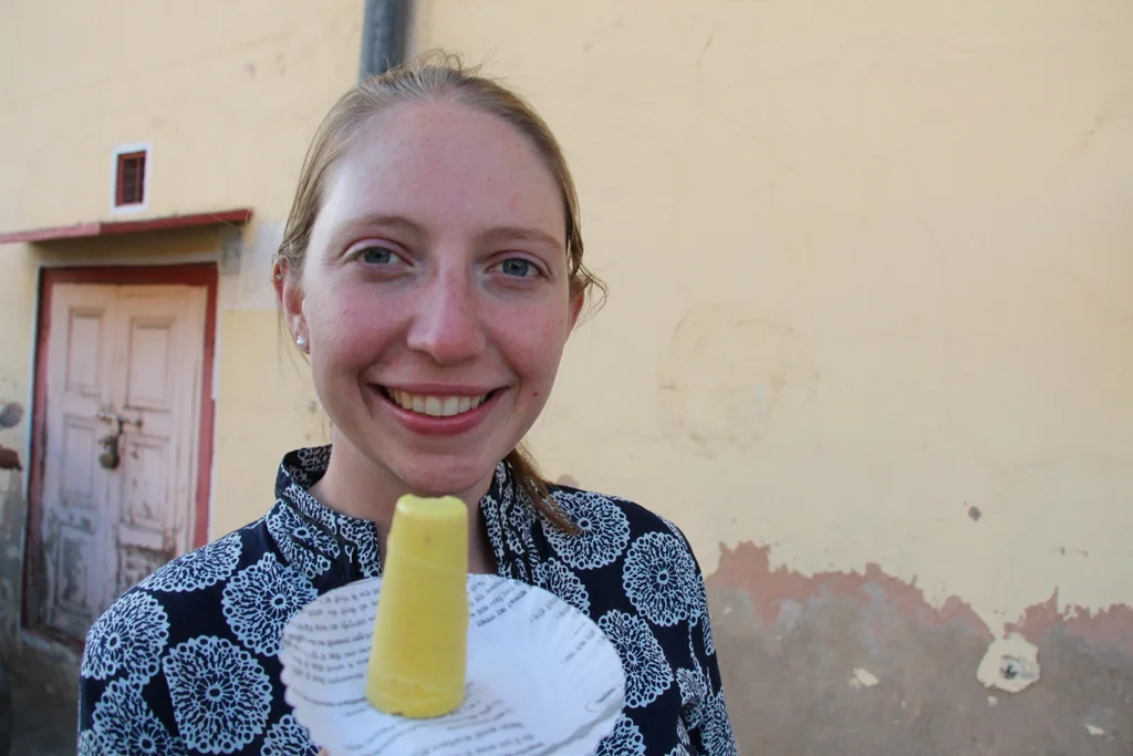 Kelsi enjoys her kulfi from the street vendor outside Jantar Mantar