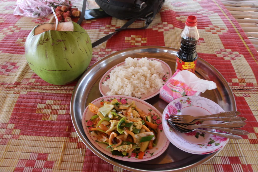 This scrumptious lunch of stir fried squid and vegetables, plus rice, and some coconut water for me came to about $7 - a "tourist price."