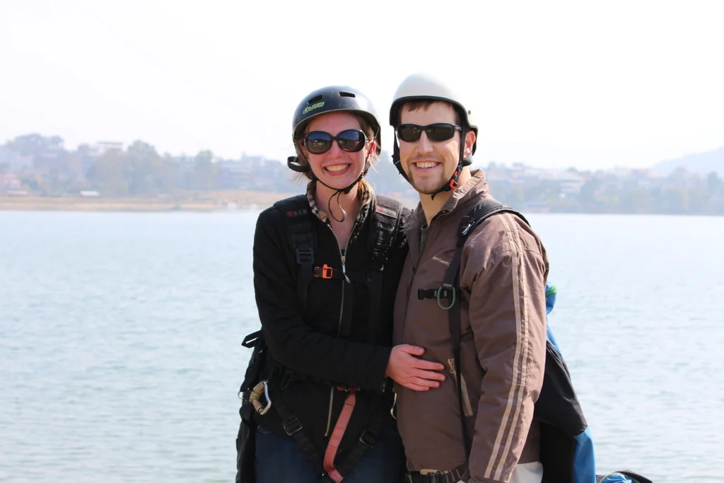 We're still in our gear from paragliding right after we landed in Pokhara, Nepal