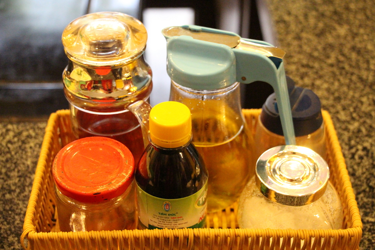 Vietnamese condiments (back row, from left) fish sauce, rice wine vinegar, salt, (front row) honey, molasses, salt. 
