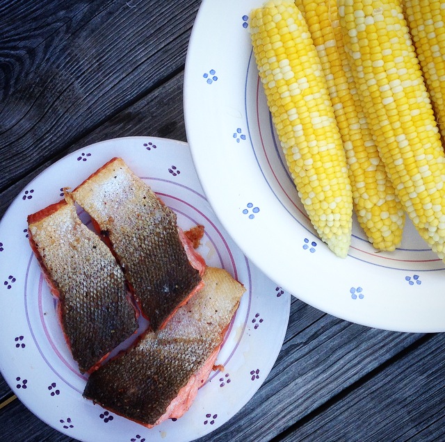 Dinner is served - crispy salmon filets and local sweet corn with butter