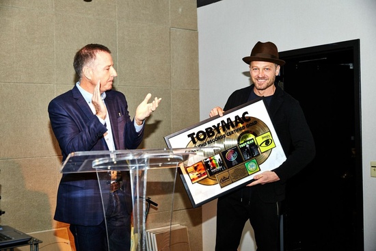 Capitol Christian Music Group President &amp; CEO Bill Hearn presents TobyMac with a plaque to commemorate five studio records RIAA Certified Gold