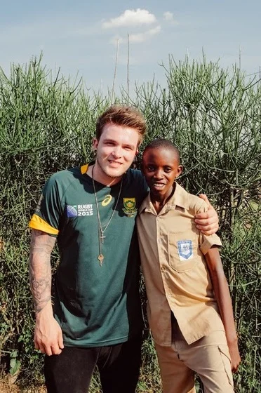 Devine with his sponsor child Evaride