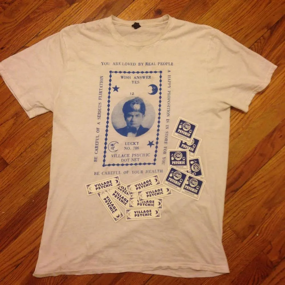 Win a Village Psychic T-Shirt and Stickers