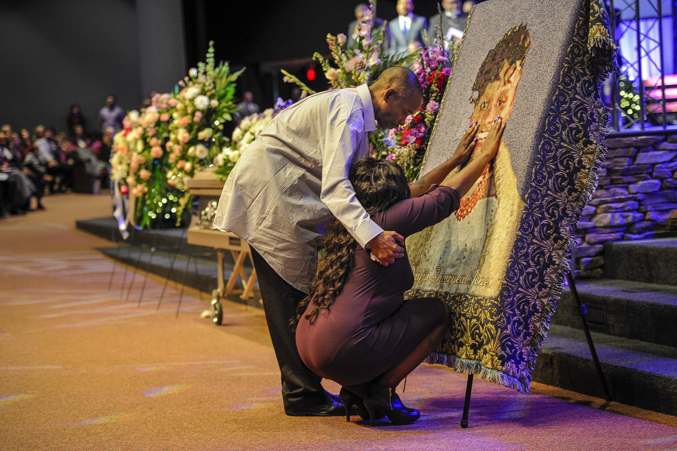 LaTesha Jones is comforted by her father Dedrick Allen as she touches the face of her daughter Cor'Dayja that is &nbsp; imprinted on a blanket during her funeral of at the &nbsp;Redemption Point Church on Sat. Nov. 26, 2016 in Chattanooga, Tenn. 