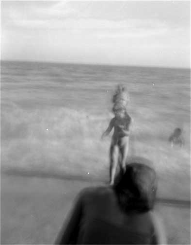"Girl and parents at the beach, Waimanalo"