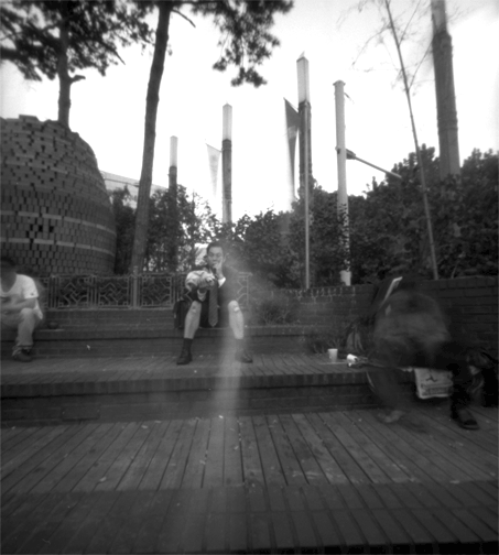 "Man sitting with bandaged knees, Seoul"