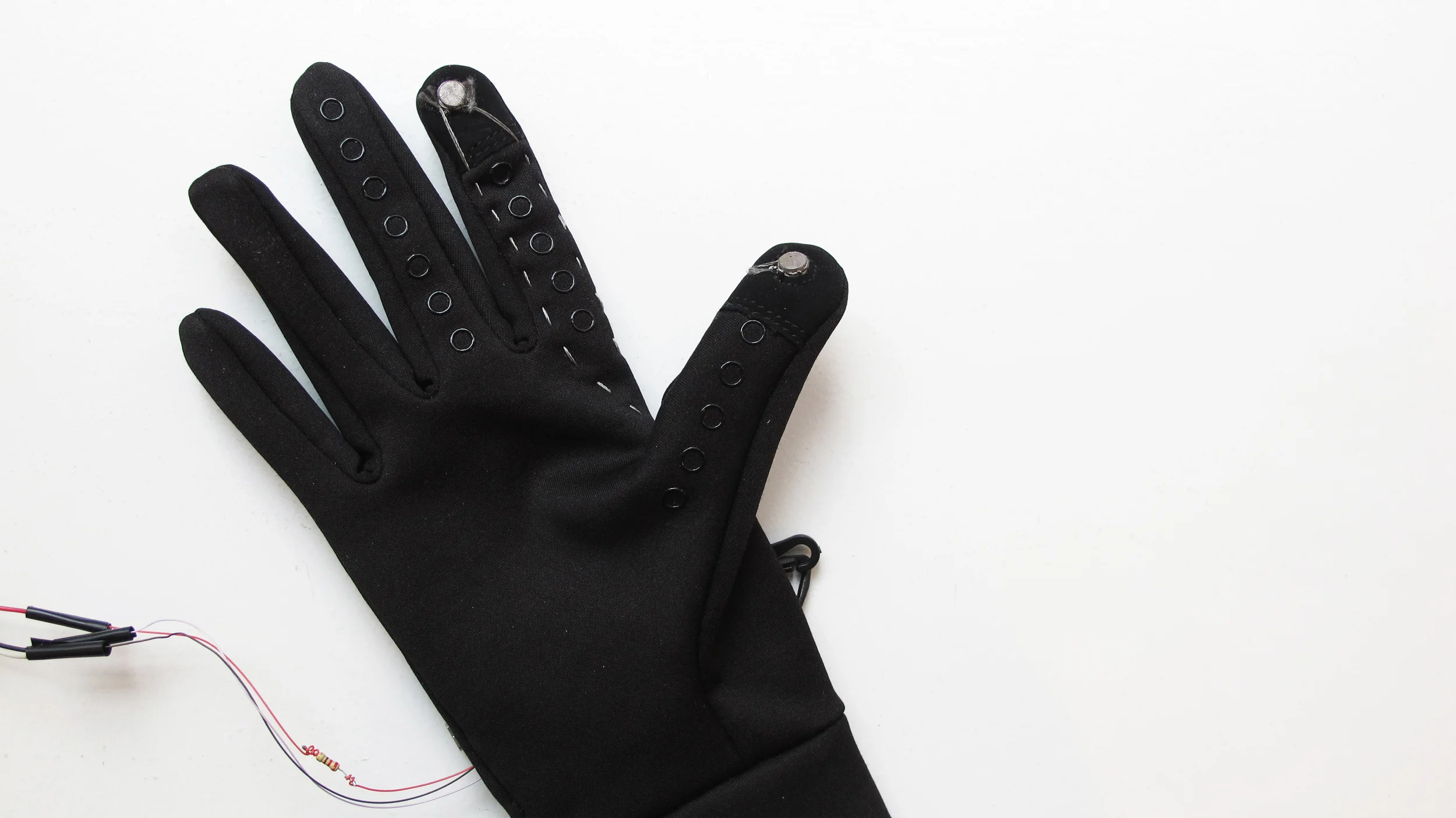 The gloves we used came with "touch pods" that work with a mobile screen. We modified them into contact switches using conductive thread. 