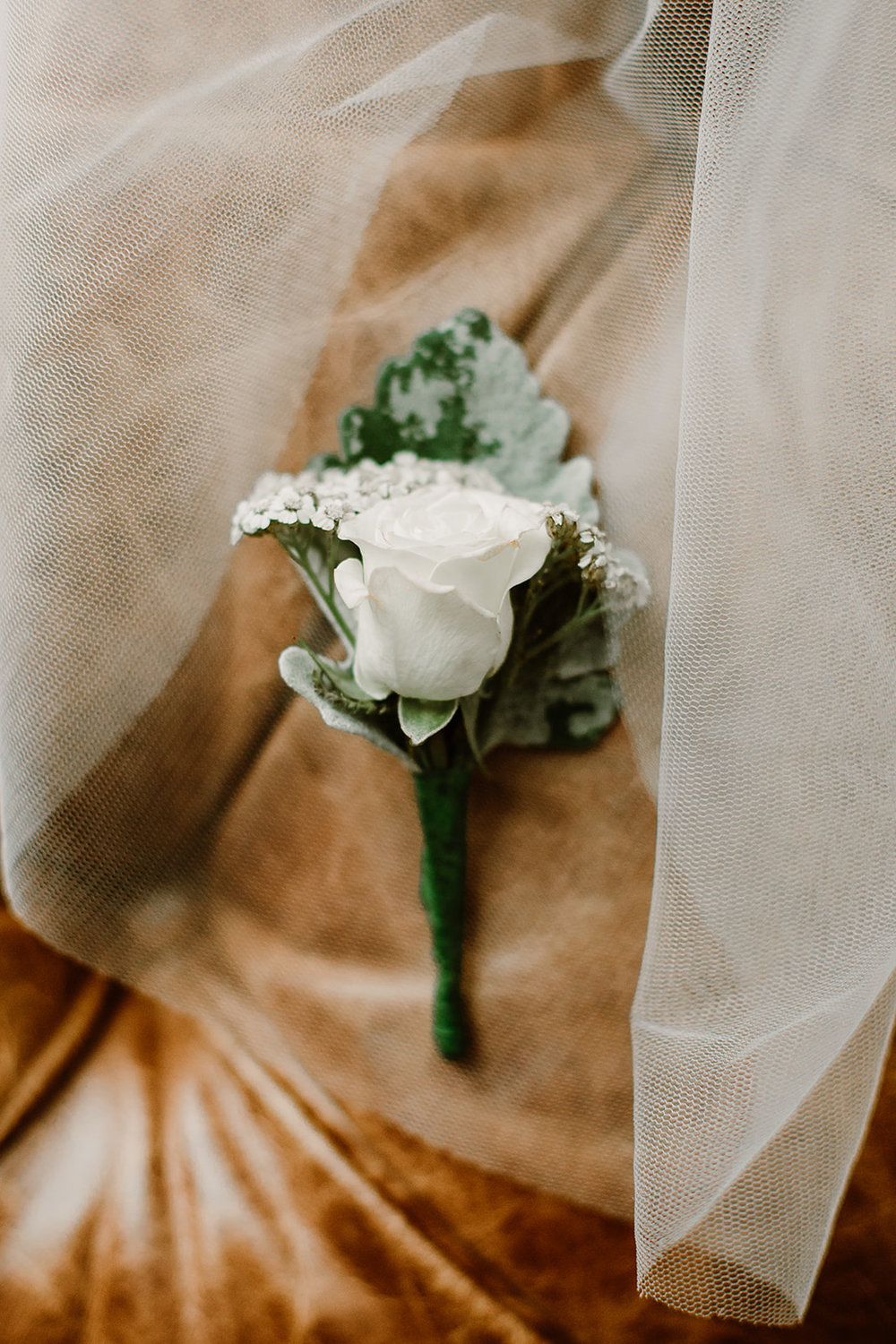  White rose boutonnière. Bride and groom getting ready at the Phoenix Park Hotel, Washington D.C. Irish wedding with green and gold accents. Sarah Mattozzi Photography. 
