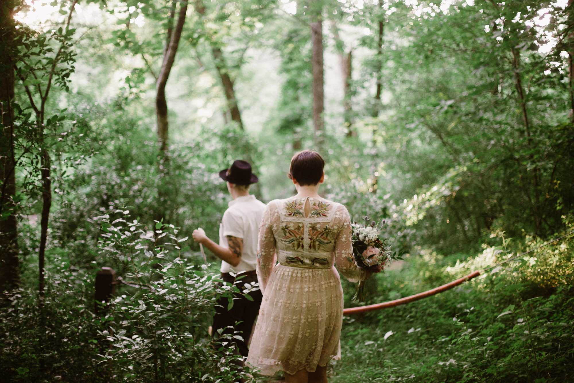  Adventurous woodland elopement in Charlottesville, VA with only the couple and their dachshund dogs. Embroidered wedding dress, wildflower inspired bouquet, and handwritten vows. Sarah Mattozzi Photography. 