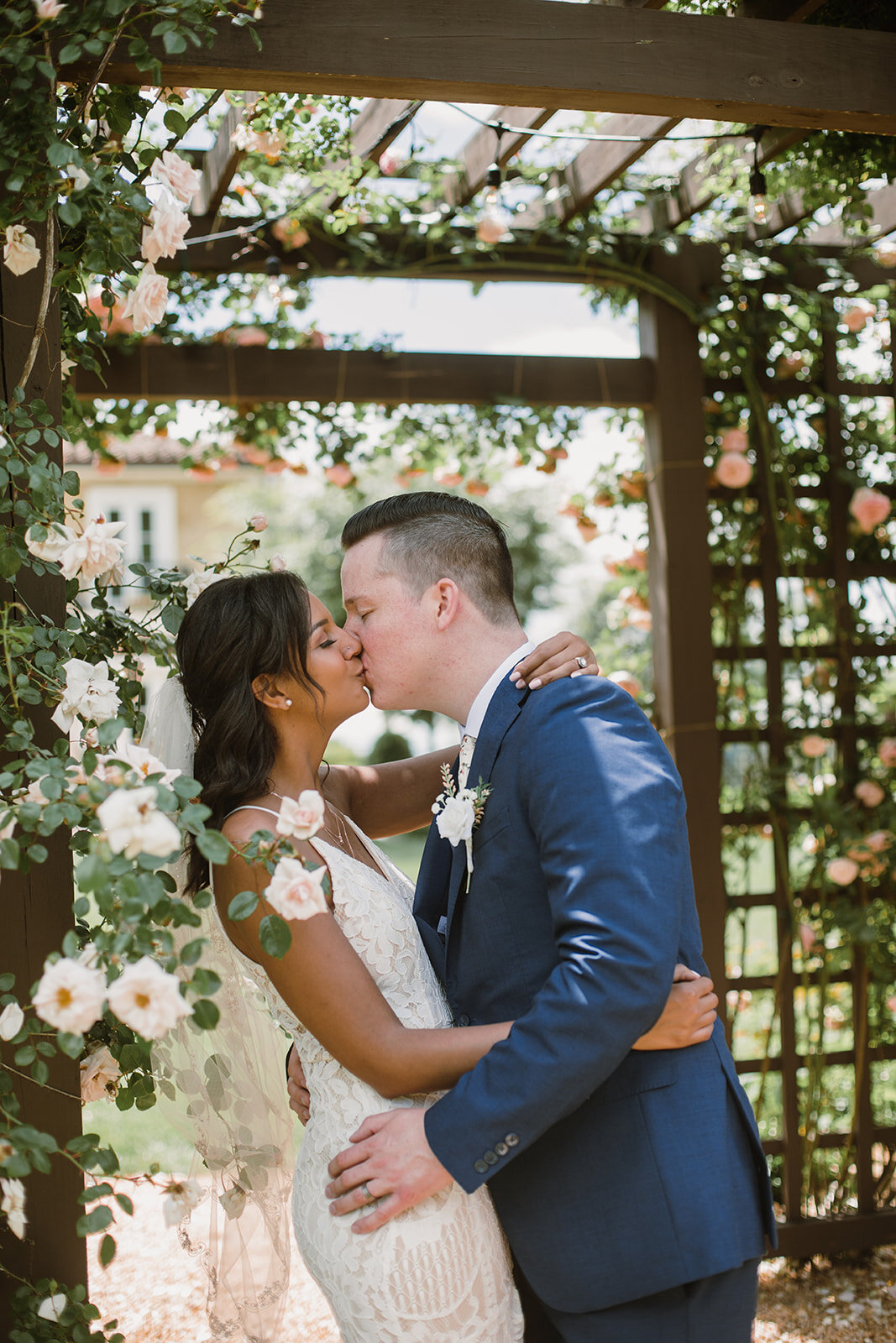  Bride and groom portraits under a rose tunnel arbor. Intimate Italian villa elopement at Monteventoso in Madison, Virginia. 