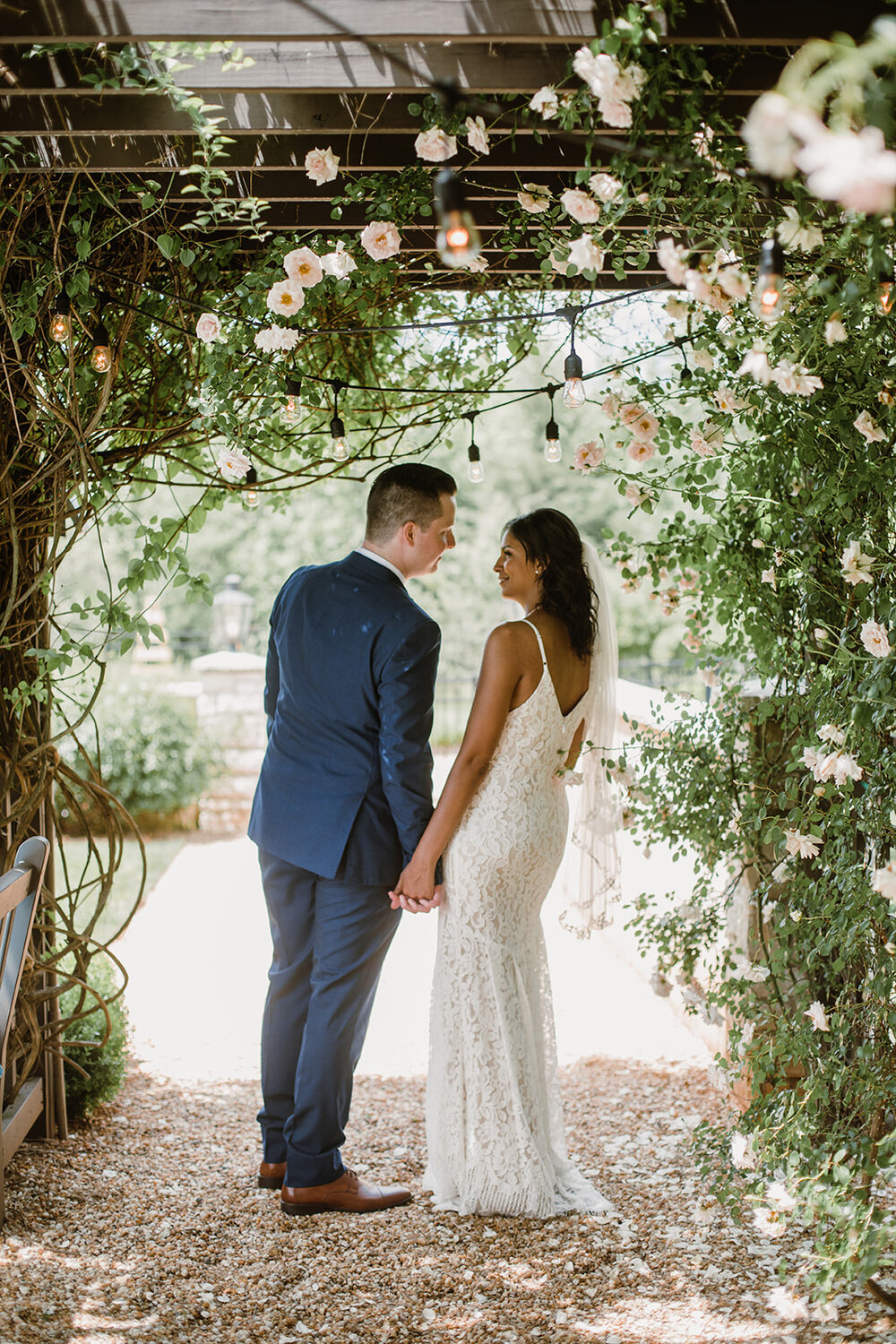  Bride and groom portraits under a rose tunnel arbor. Intimate Italian villa elopement at Monteventoso in Madison, Virginia. 