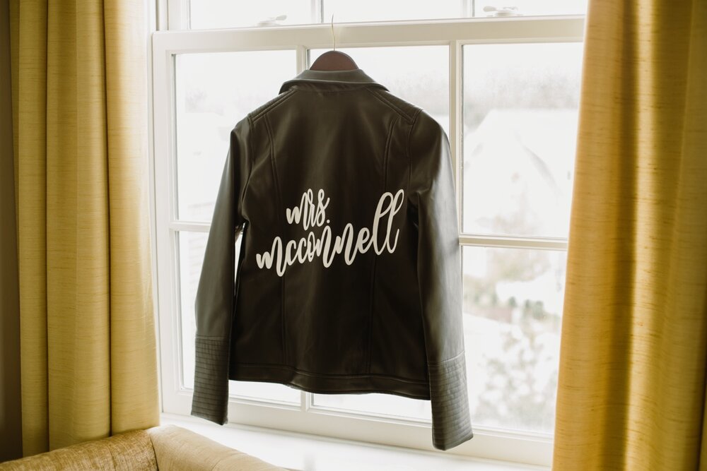  Leather custom bride jacket | Sarah Mattozzi Photography | Black tie wedding at The Historic Cavalier Hotel, Virginia Beach | Tropical, elegant wedding inspiration, black tux groom, glam bride, greenery bouquets, sentimental, classic, minimalist wed