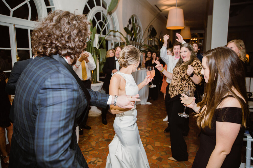  Reception dancing | Sarah Mattozzi Photography | Black tie wedding at The Historic Cavalier Hotel, Virginia Beach | Tropical, elegant wedding inspiration, black tux groom, glam bride, greenery bouquets, sentimental, classic, minimalist wedding. 