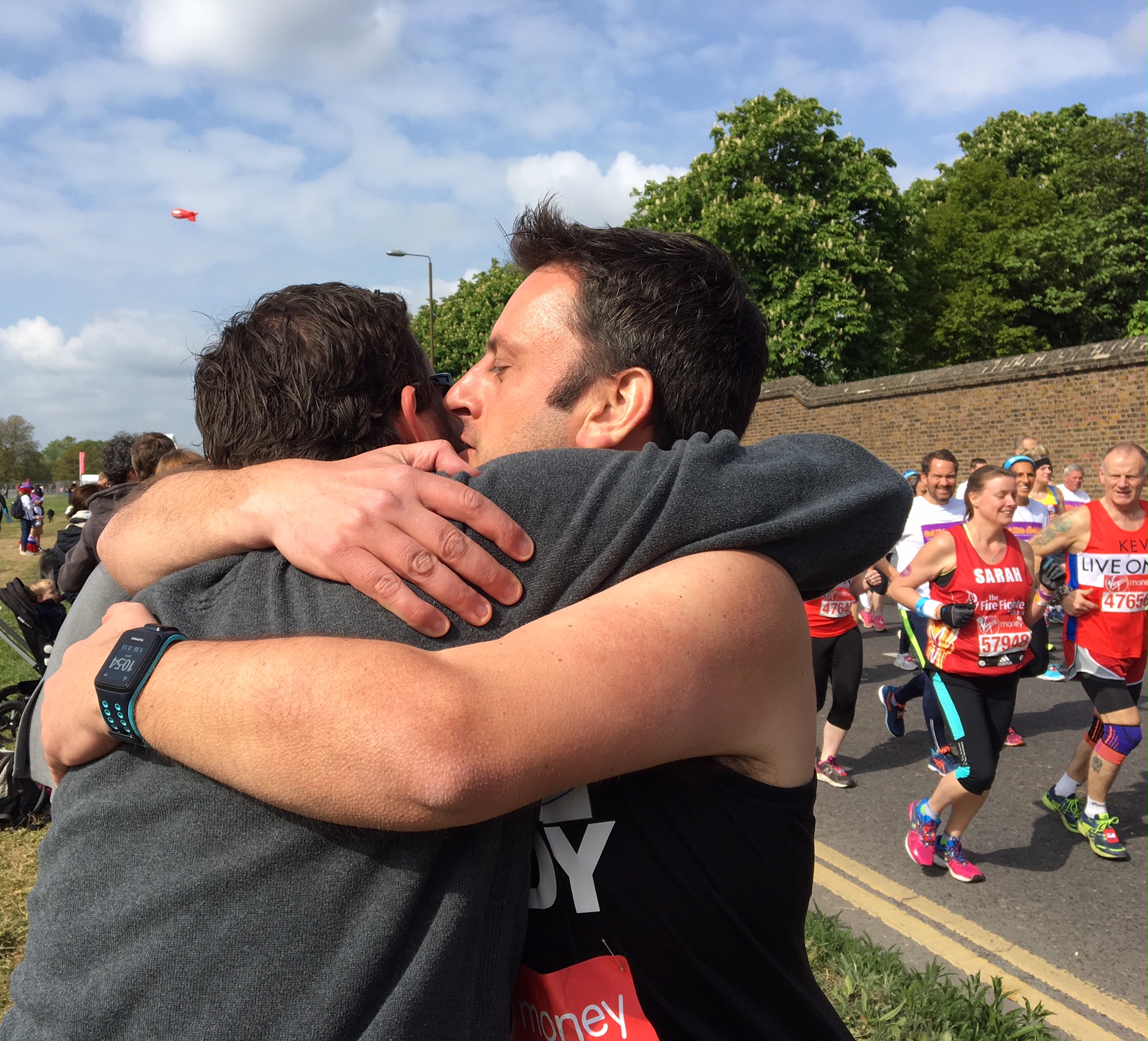 I loved this moment when a runner spotted his cheering friend in the crowd and stopped for a supportive hug. I snapped it and, after everyone passed, sent it to the friend who immediately sent it to the runner's family. 