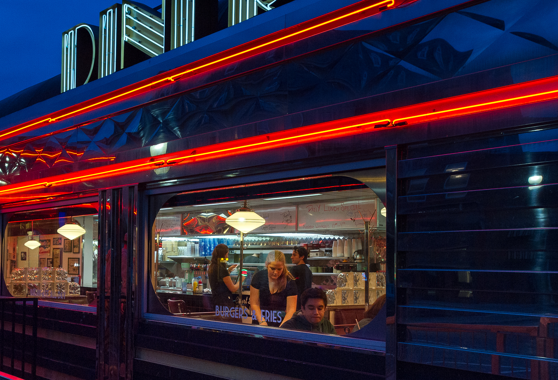 Meaghan Glanville, of Ann Arbor, Michigan, clears a table at Court Street Diner in Athens, Ohio on the evening of Sunday, January 18, 2015. Glanville works part-time waiting tables at the the 1950s-themed diner.