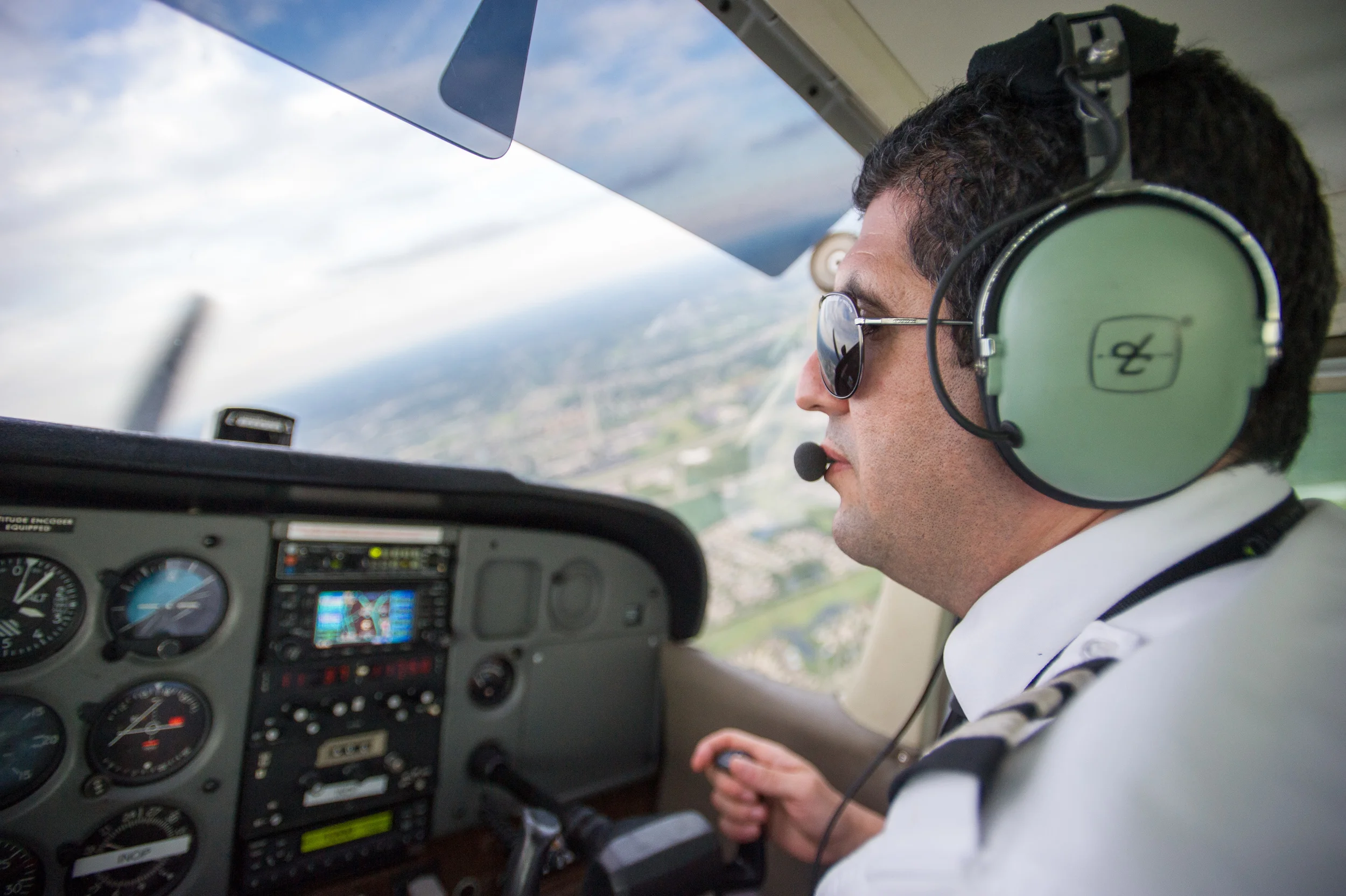 Reda Elidrissi of Dayton, Ohio, flies a Cessna 172RG at the annual Runway Fest held by Dayton-Wright Brothers Airport on August 7th, 2015, in Miamisburg, Ohio. Elidrissi has been flying for seven years and currently works as a flight instructor at the Wright Brothers Airport. "Don't ever work," Elidrissi says. "Because if you're doing what you truly love, then it is never work." (©Sarah Stier 2015)