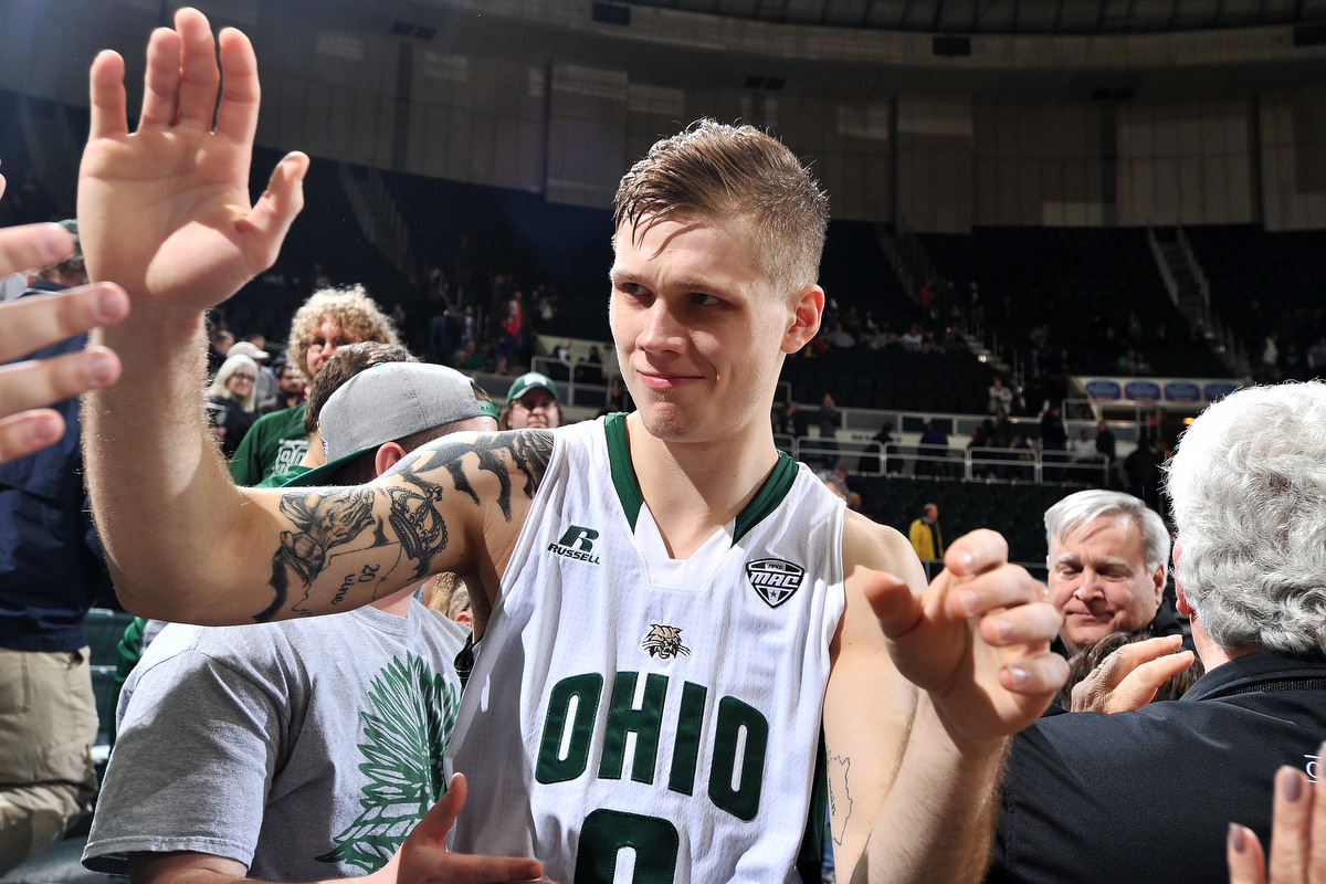 The Ohio Bobcats men's team's only senior, Treg Setty, gives high fives to fans as he walks off the court after a 103-96 win over Buffalo. Setty earned a career-high 24 points during the game.