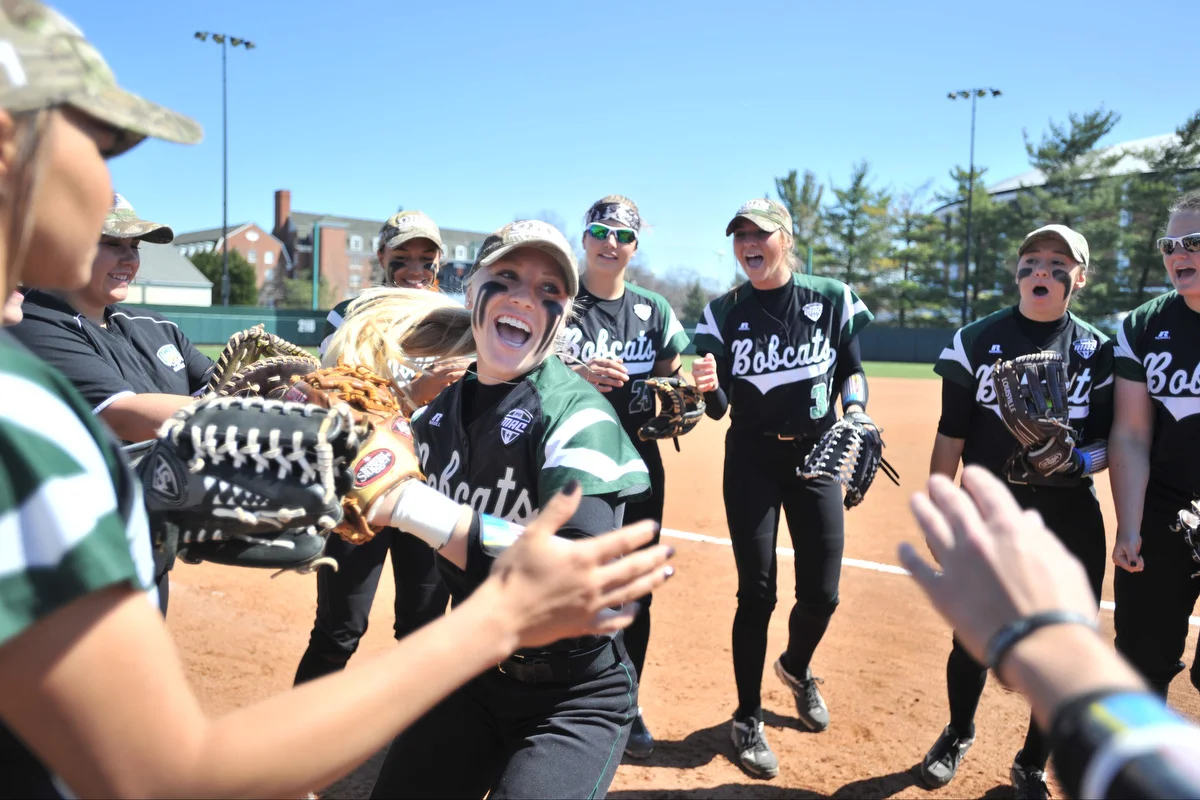 Ohio University sophomore Taylor Saxton high-fives her teammates as she is introduced before the Bobcats' game against Western Michigan on March 26, 2016, in Athens, Ohio. The Bobcats won the three-game series that weekend. ©2016 Sarah Stier | Ohio Athletics