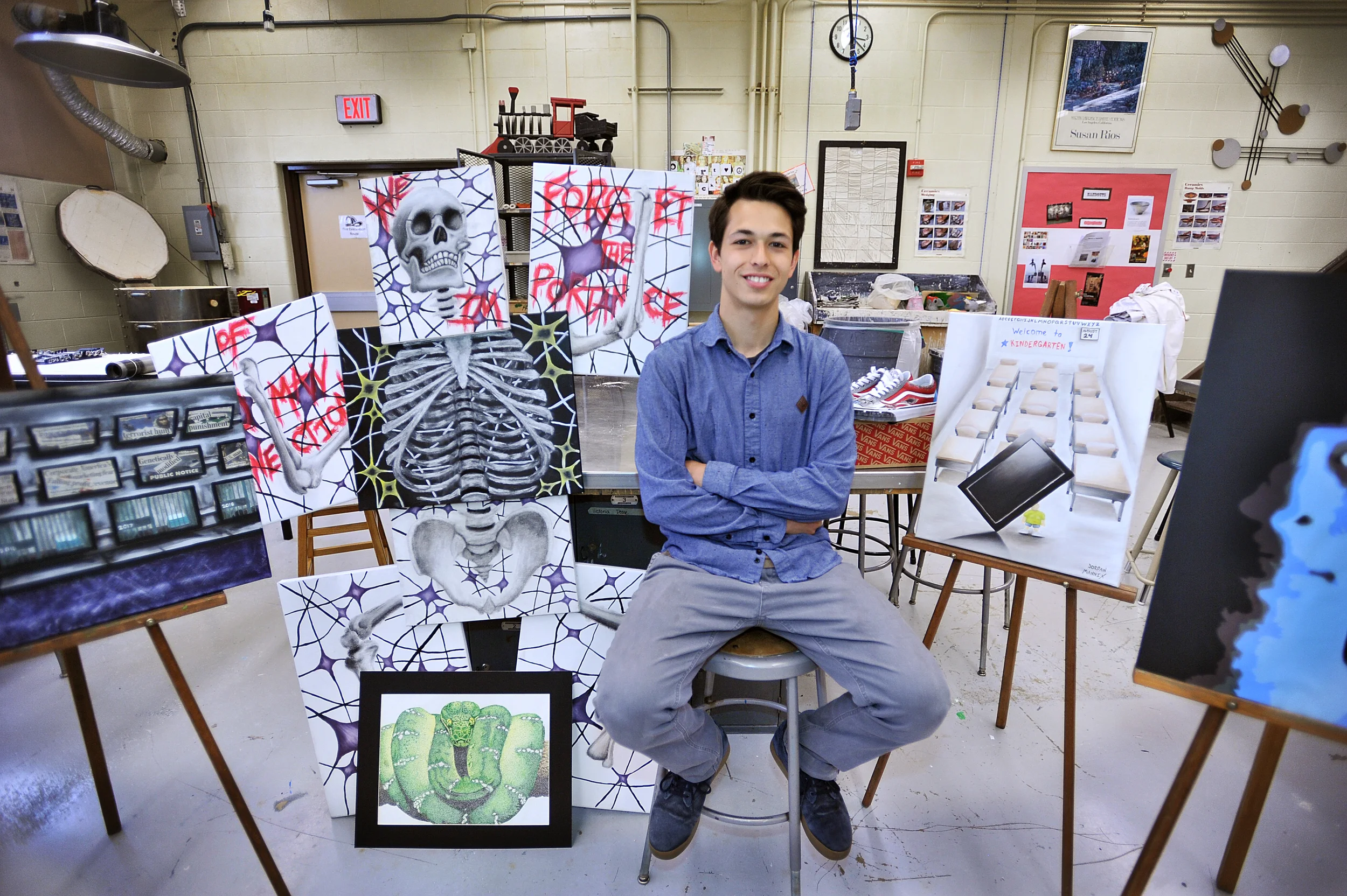 Jordan Mannix, a senior at Wilson High School, poses for a portrait on May 17, 2016, with some of his favorite pieces of artwork that he's done this year.