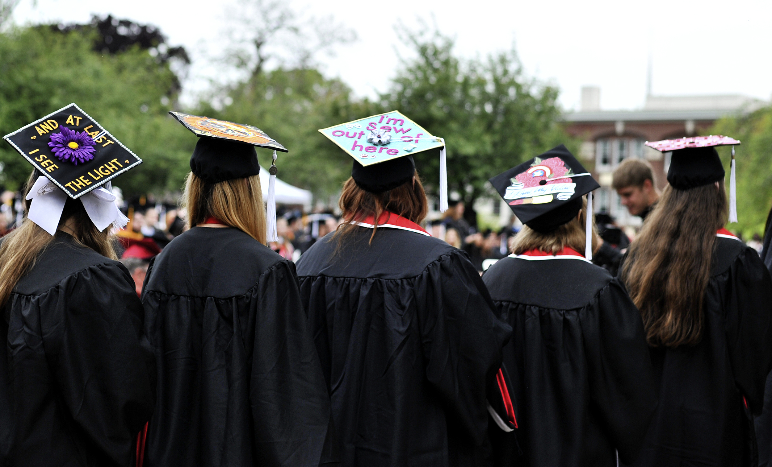 Graduates at the Albright College commencement ceremony on May 22, 2016, wait to receive their degrees. "I'm sew over it," reads one student's cap. (Reading Eagle: Sarah Stier)