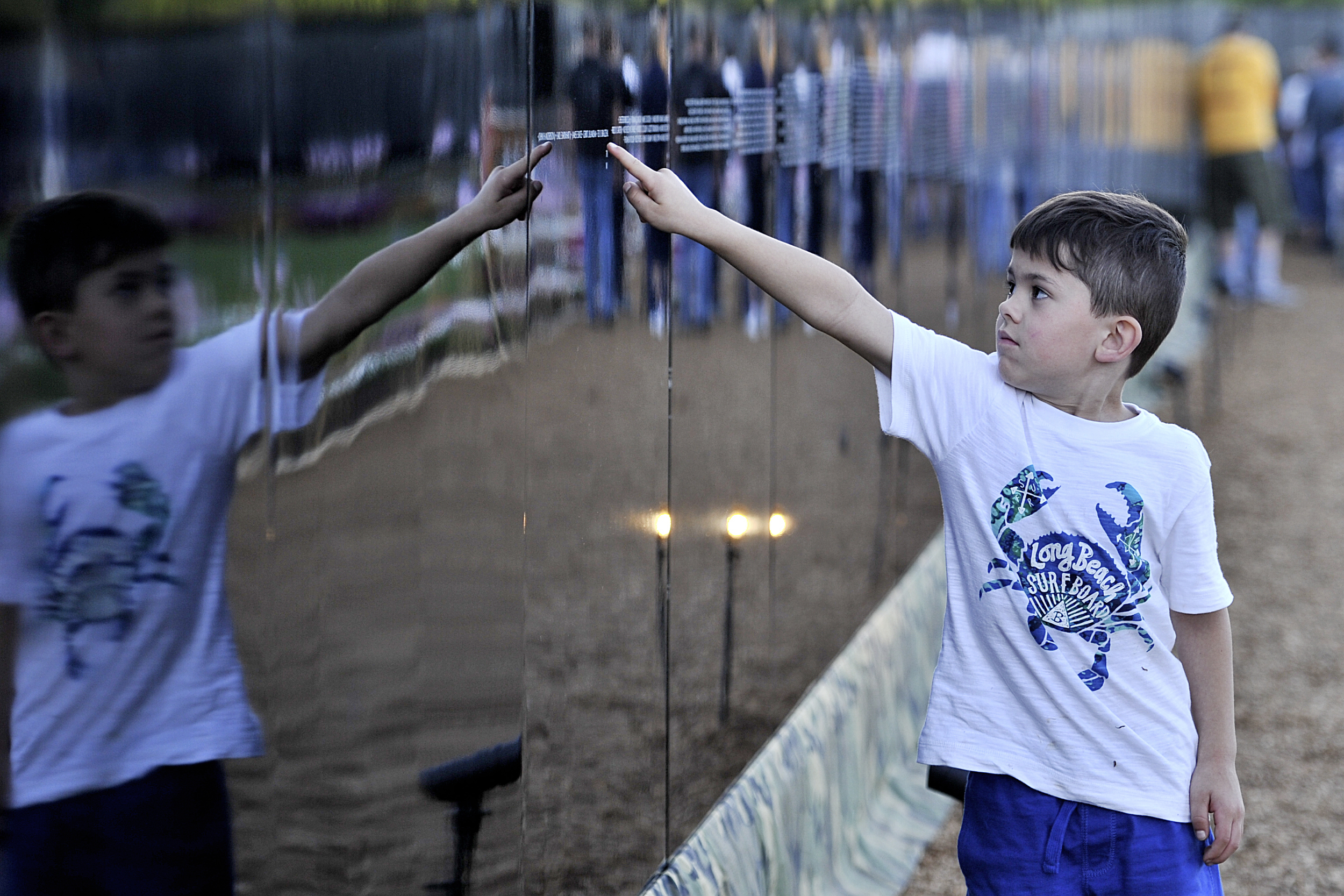 Gavin Jacobs, 6, of Leesport looks at the names on the wall at the Opening Ceremony for the Vietnam Memorial Moving Wall in Muhlenberg, PA, on June 9, 2016. (Sarah Stier: Reading Eagle)