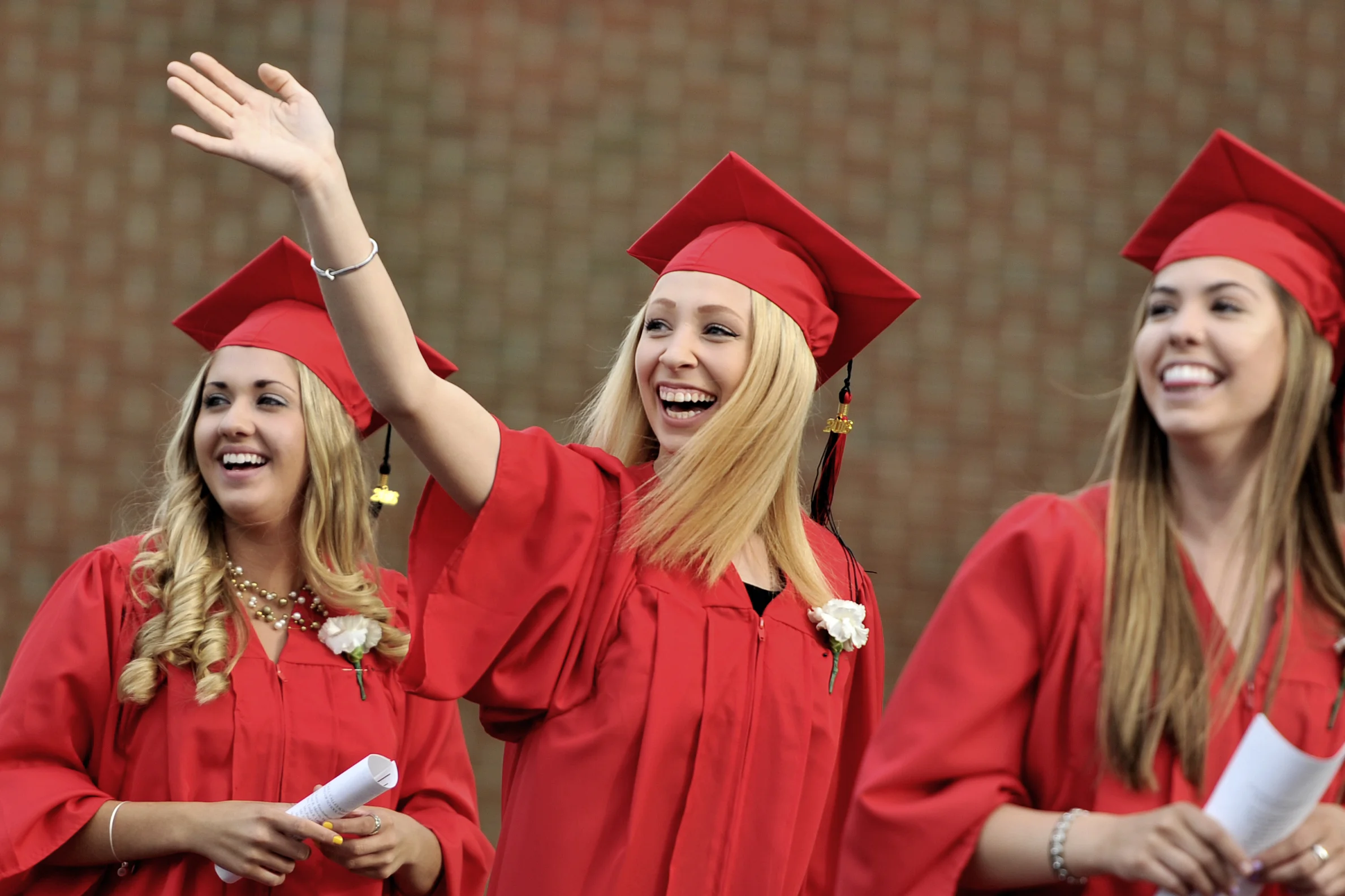 Kaitlynn Tindall waves to a friend on June 10, 2016, before the Schuylkill Valley High School commencement ceremony. (Sarah Stier: Reading Eagle)