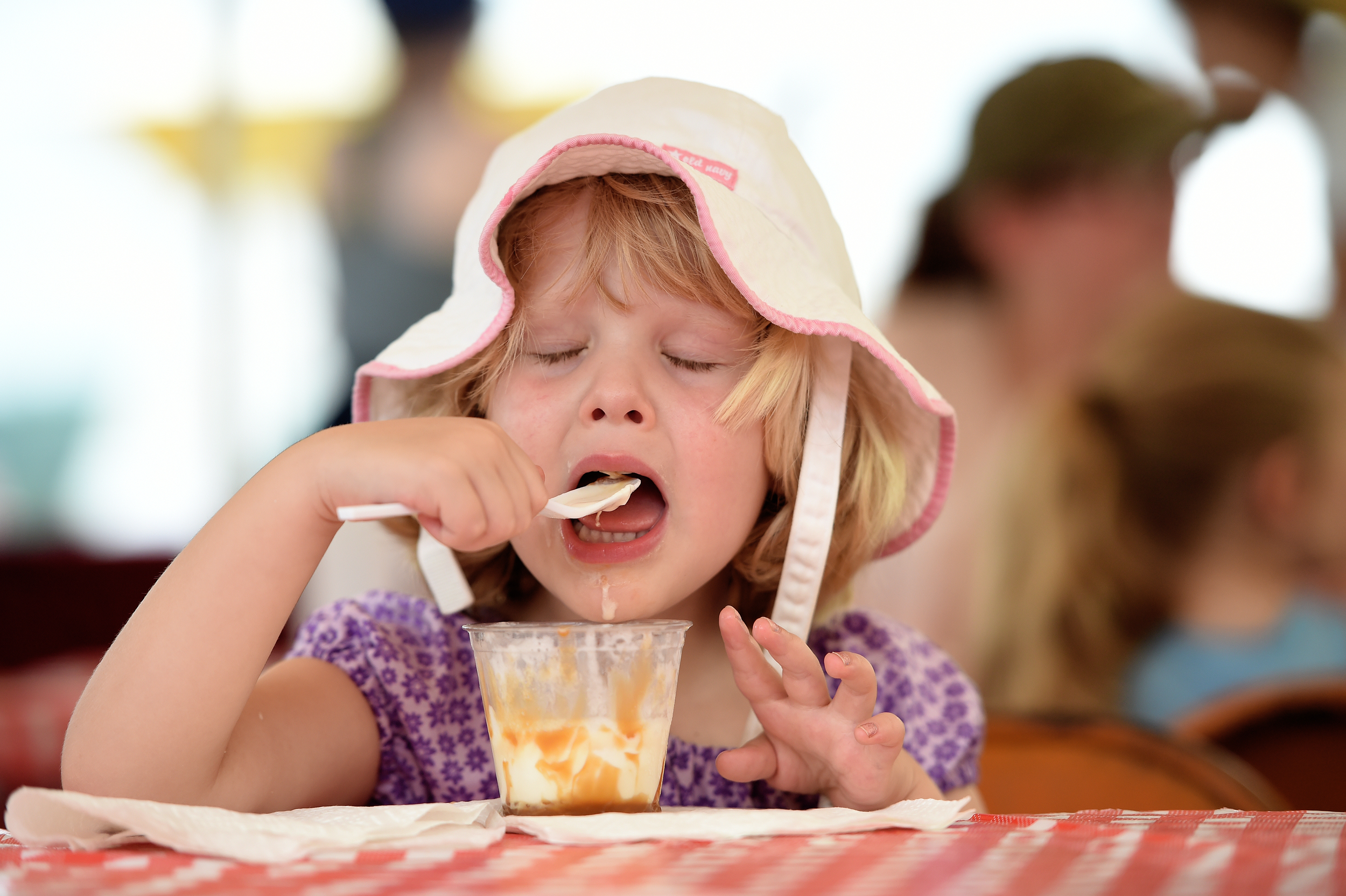 Asha Hostetter, 3, of Columbus, Georgia, enjoys banana ice cream at the Kutztown Folk Festival in Kutztown, PA, on July 7, 2016. (Reading Eagle: Sarah Stier)