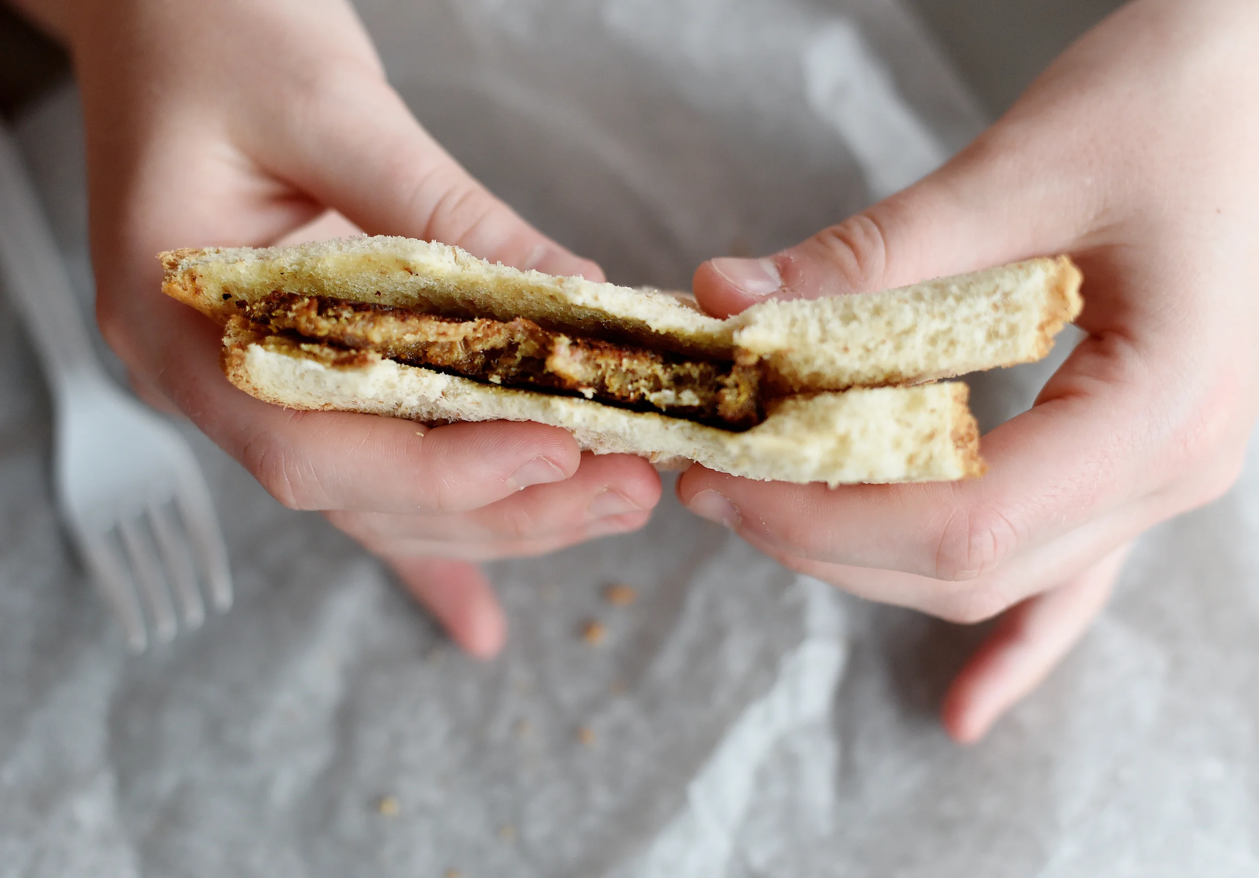 Reading Eagle reporter Jillian Clemente tries a scrapple sandwich for her column on food at the Kutztown Folk Festival in Kutztown, PA, on July 7, 2016. (Reading Eagle: Sarah Stier)