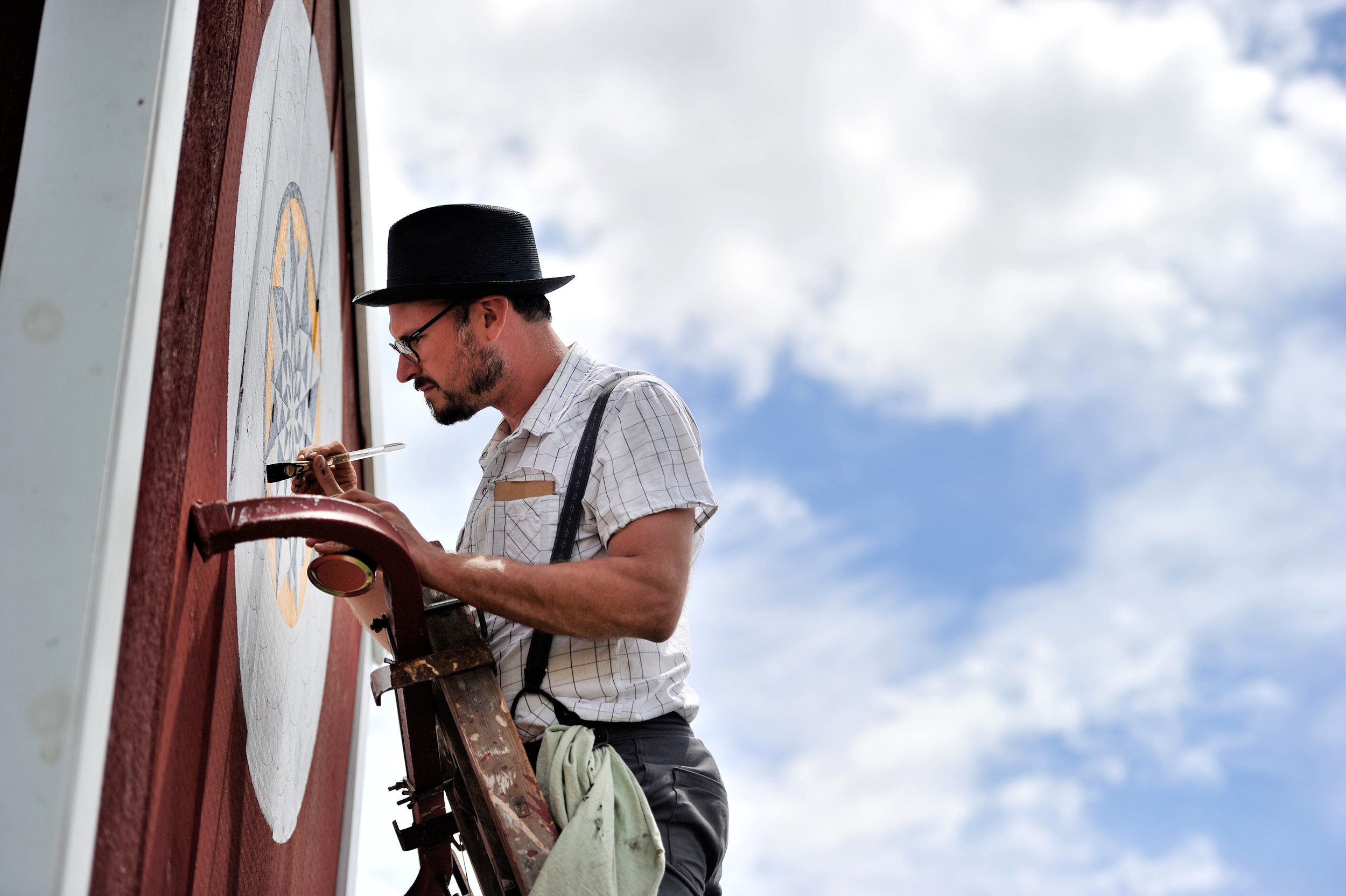 Patrick Donmoyer of Kutztown paints barn stars at the Kutztown Folk Festival in Kutztown, PA, on July 2, 2016. (Reading Eagle: Sarah Stier)