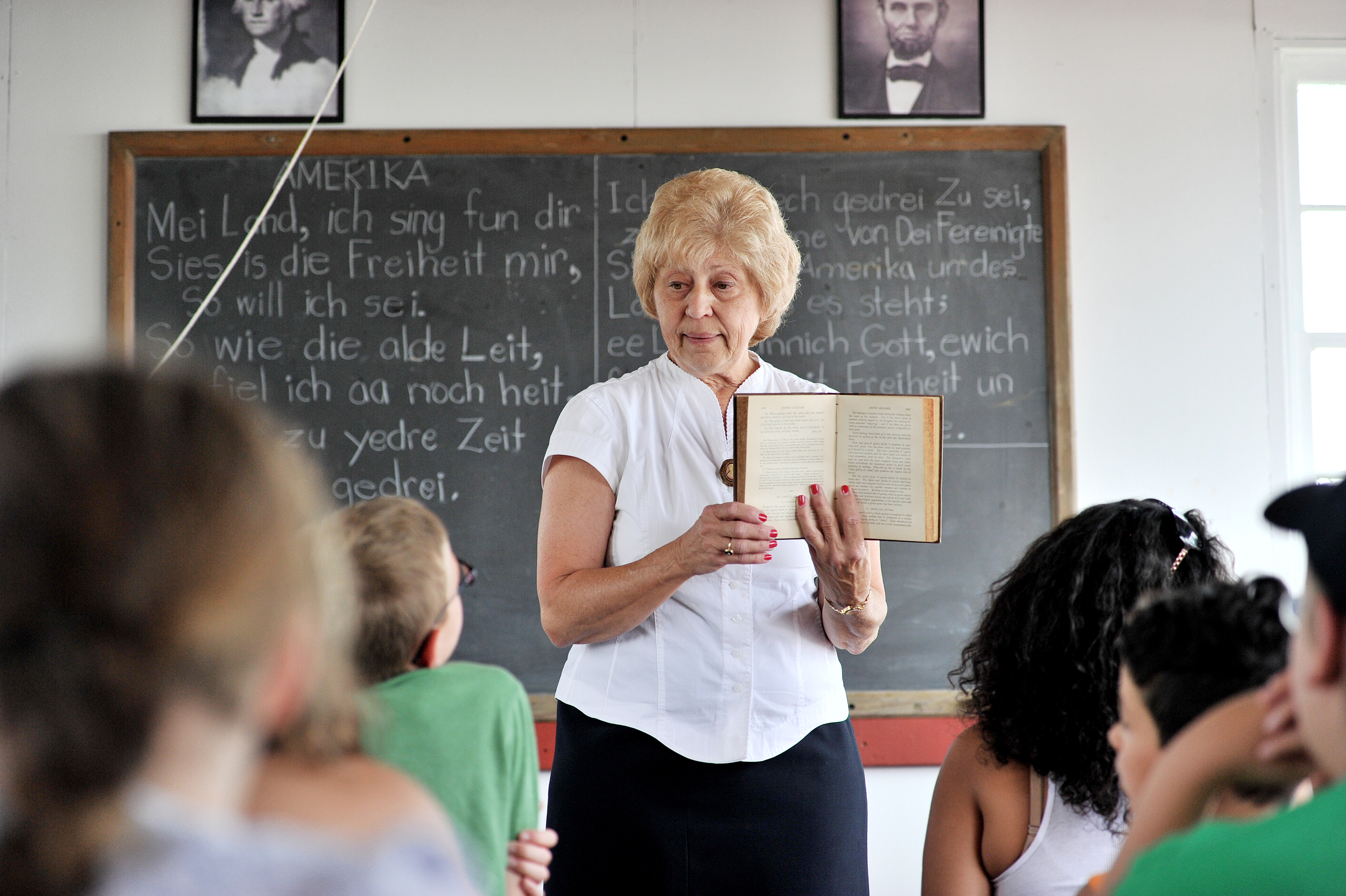 Laureen Hoffman of Kutztown demonstrates what it was like to go to school in a one-room schoolhouse at the Kutztown Folk Festival in Kutztown, PA, on July 2, 2016. (Reading Eagle: Sarah Stier)