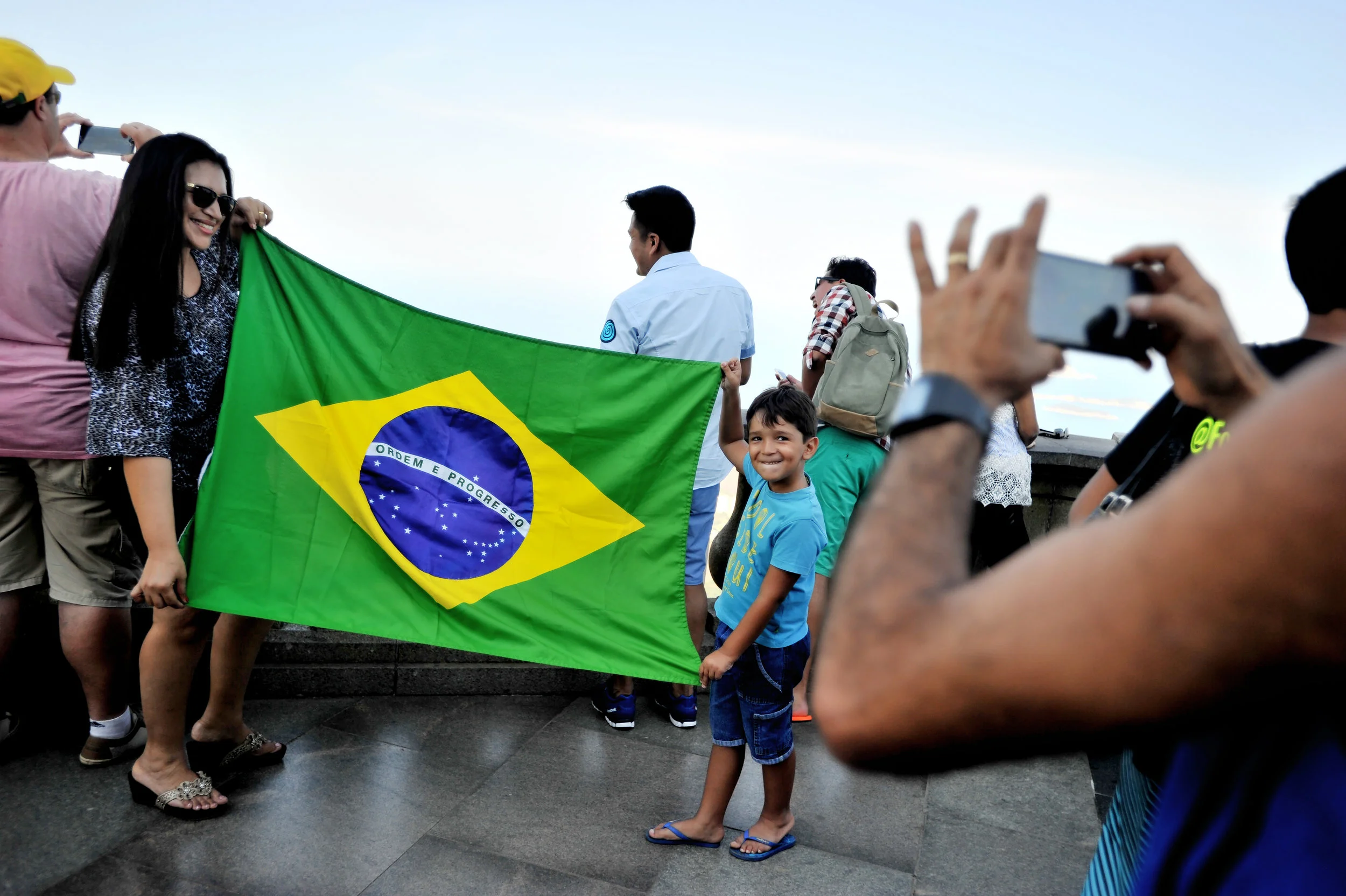 Denilza Rodrigues Dutua of Manaus and her son, Daniel, 5, pose with the Brazilian flag at the Statue of Christ the Redeemer in Rio de Janeiro, Brazil, on August 5, 2016. (Sarah Stier | Ball State at the Games)
