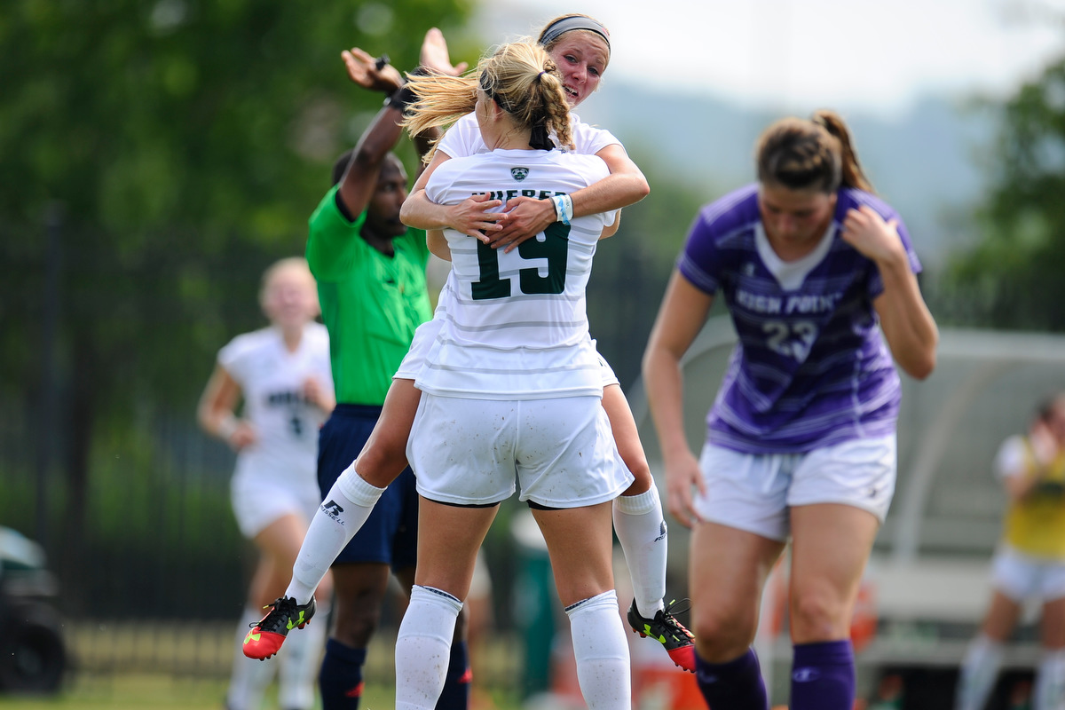 Bryce Hueber (19) and Sydney Leckie (18) embrace after scoring a goal for the Bobcats during their game against High Point on August 28, 2016, in Athens, Ohio. The Bobcats lost the game in overtime.