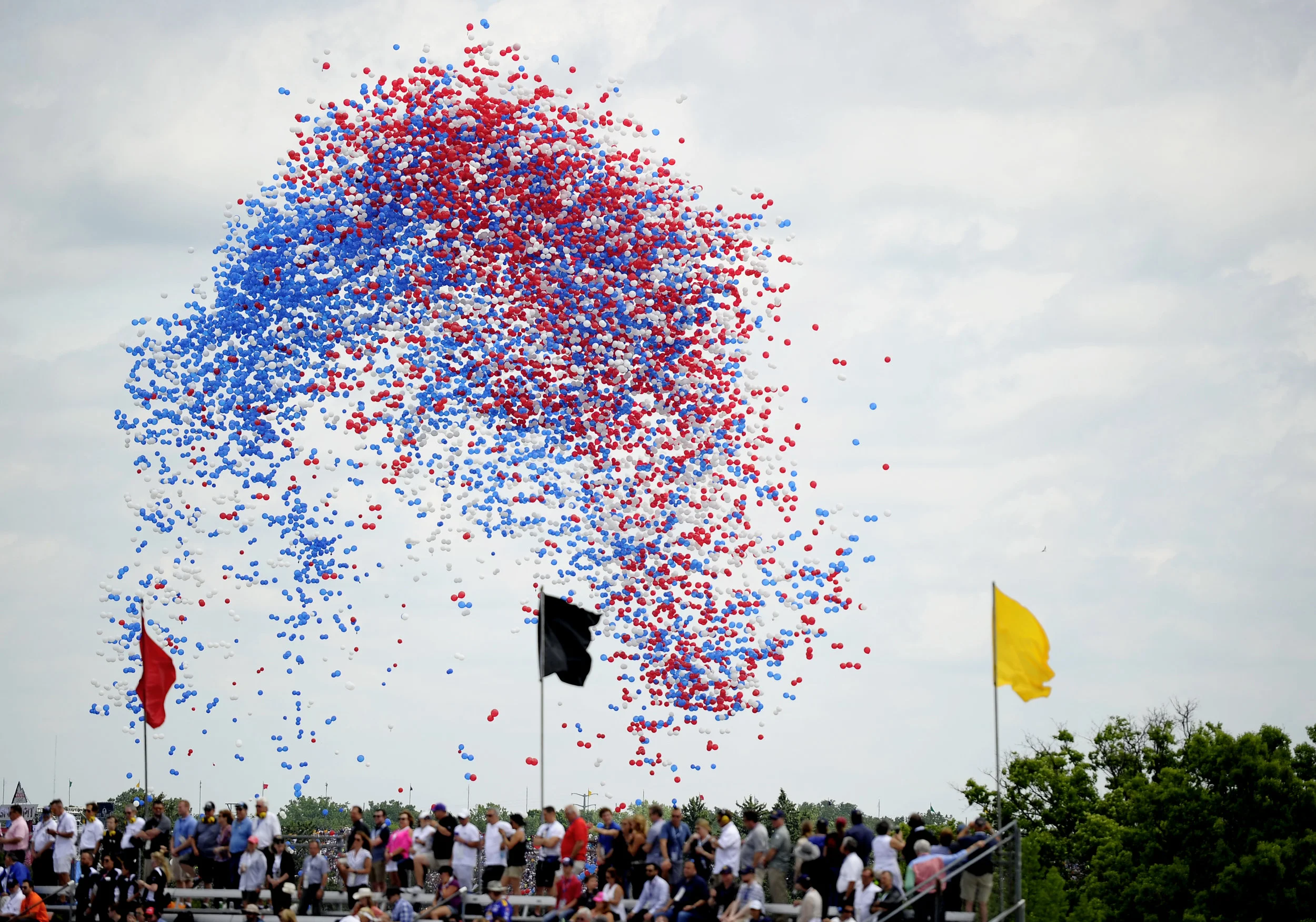 Balloons are released during Jim Cornelison's performance of "Back Home Again in Indiana" at the 101st running of the Indianapolis 500 at Indianapolis Motor Speedway on Sunday, May 28, 2017.