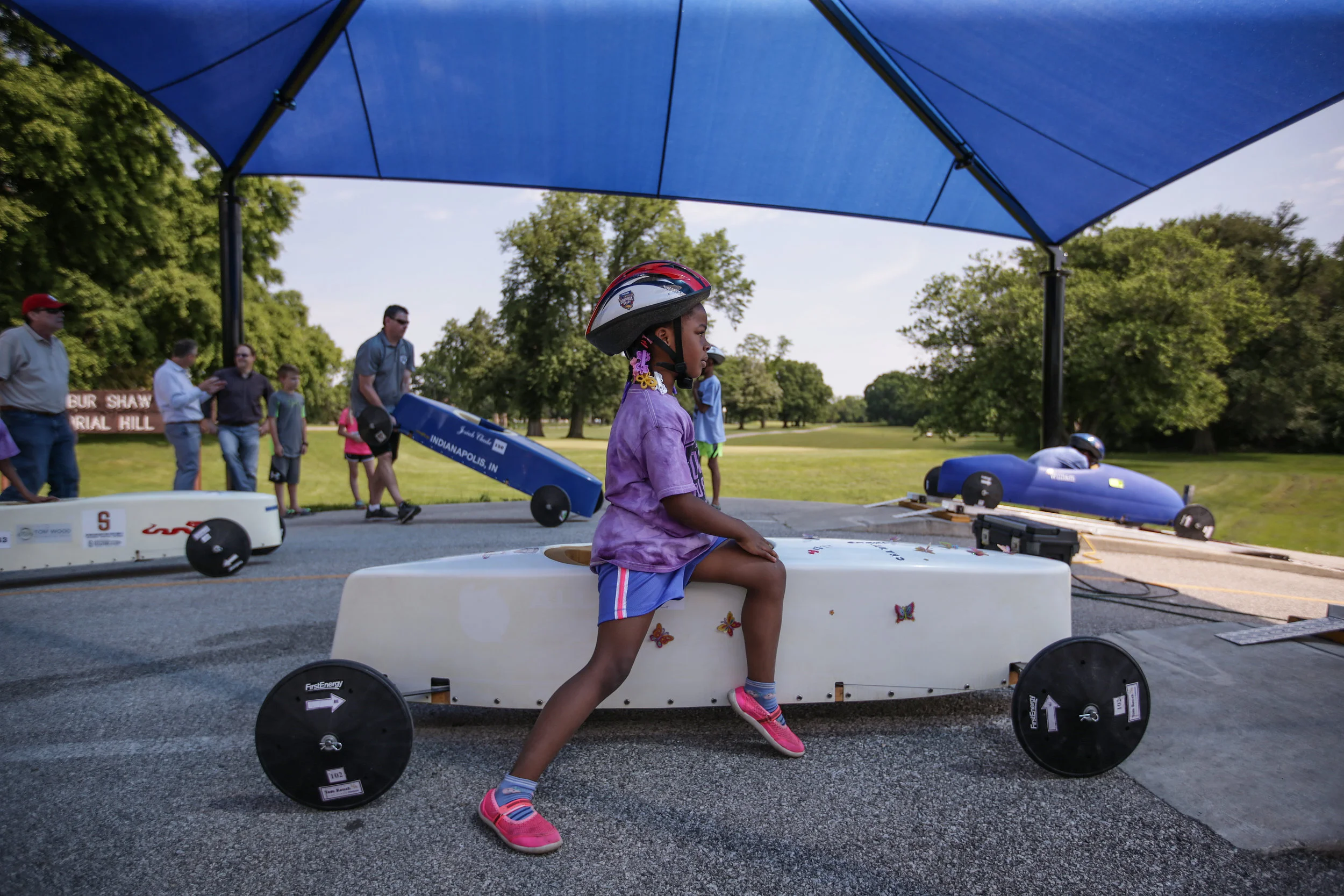 A young driver watches the start of another race while she waits for her own at the 15th Annual Mayor's Cup on Saturday, June 3, 2017.