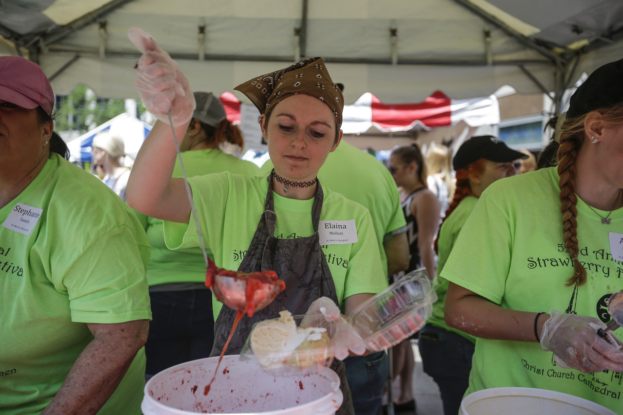Elaina Mellott scoops strawberries at the 52nd Annual Strawberry Festival at Monument Circle in downtown Indianapolis on Thursday, June 8, 2017.