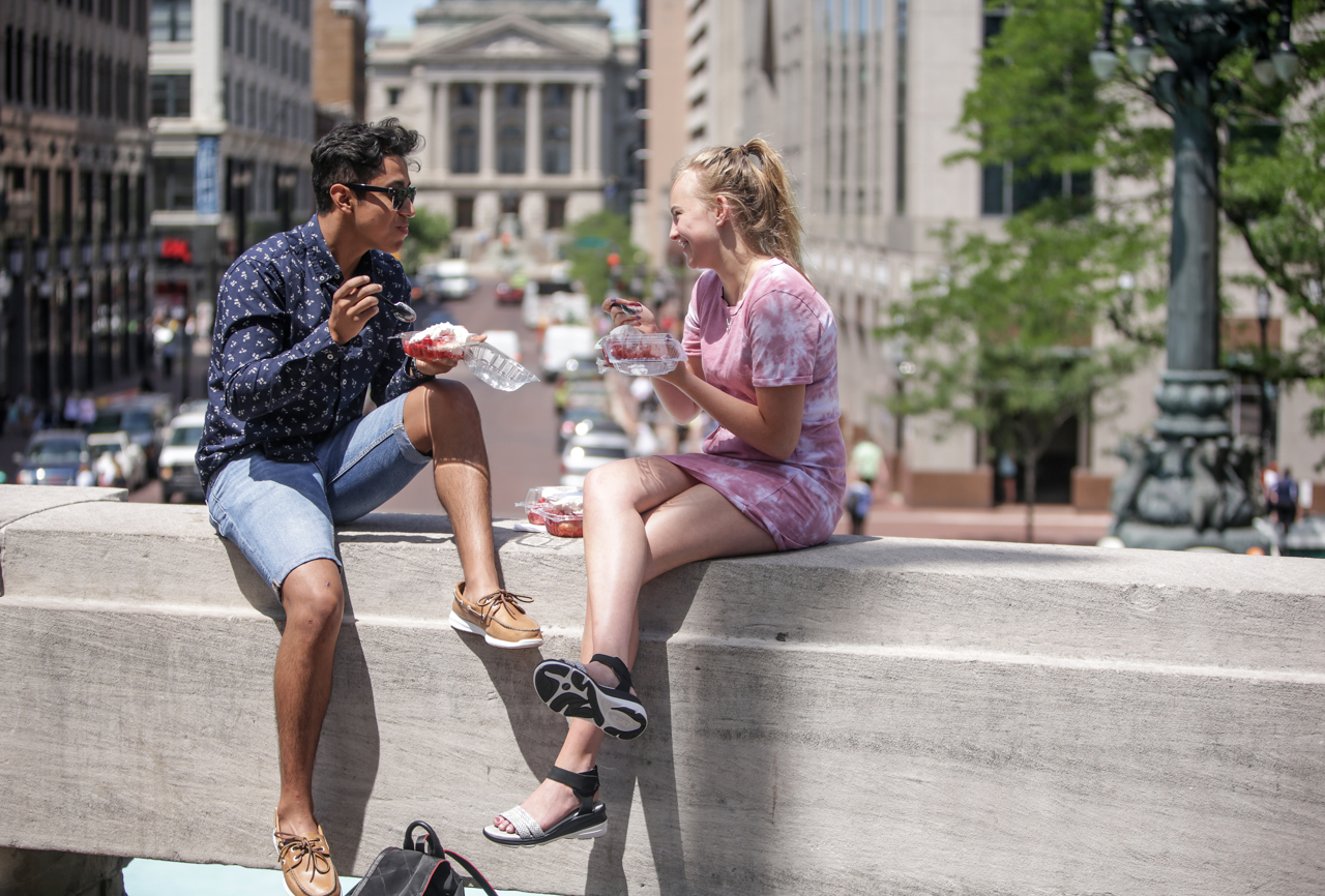 Vivian Grant, 17, and Michael Catano enjoy strawberry shortcake on a ledge of Monument Circle at the 52nd Annual Strawberry Festival in downtown Indianapolis on Thursday, June 8, 2017.