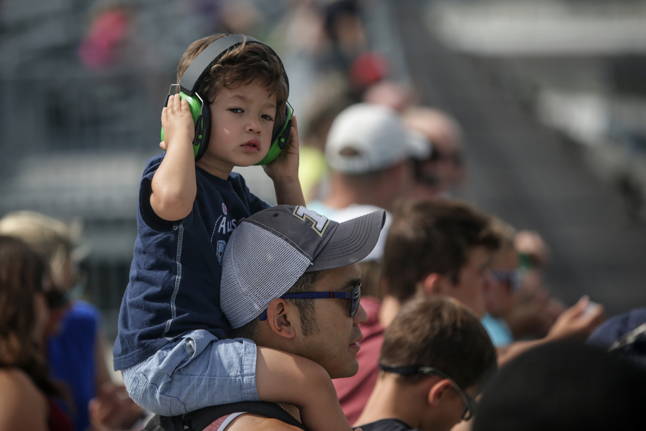 Connor Lin, 3, sits atop his father, Mike's, shoulders at the SVRA Brickyard Vintage Race at Indianapolis Motor Speedway on Saturday, June 17, 2017.