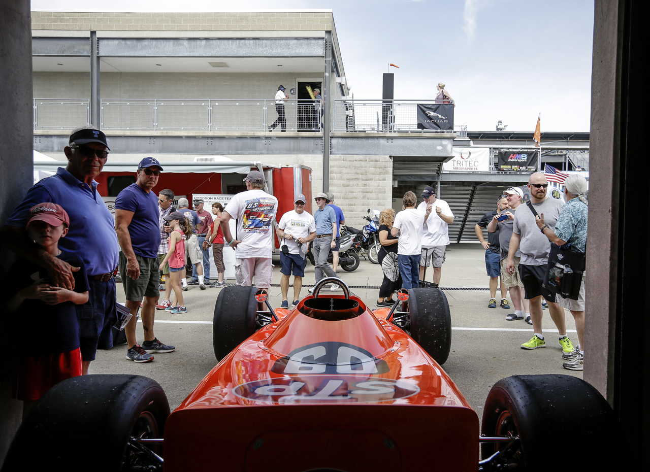 Fans take photos of cars in the garages at the SVRA Brickyard Vintage Race at Indianapolis Motor Speedway on Saturday, June 17, 2017.