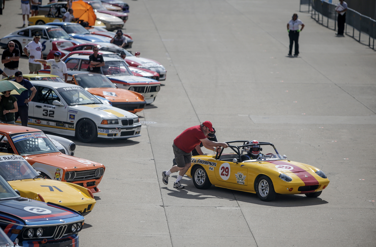 Crew members try to get a vintage car started prior to the start of a race at the SVRA Brickyard Vintage Race at Indianapolis Motor Speedway on Saturday, June 17, 2017.