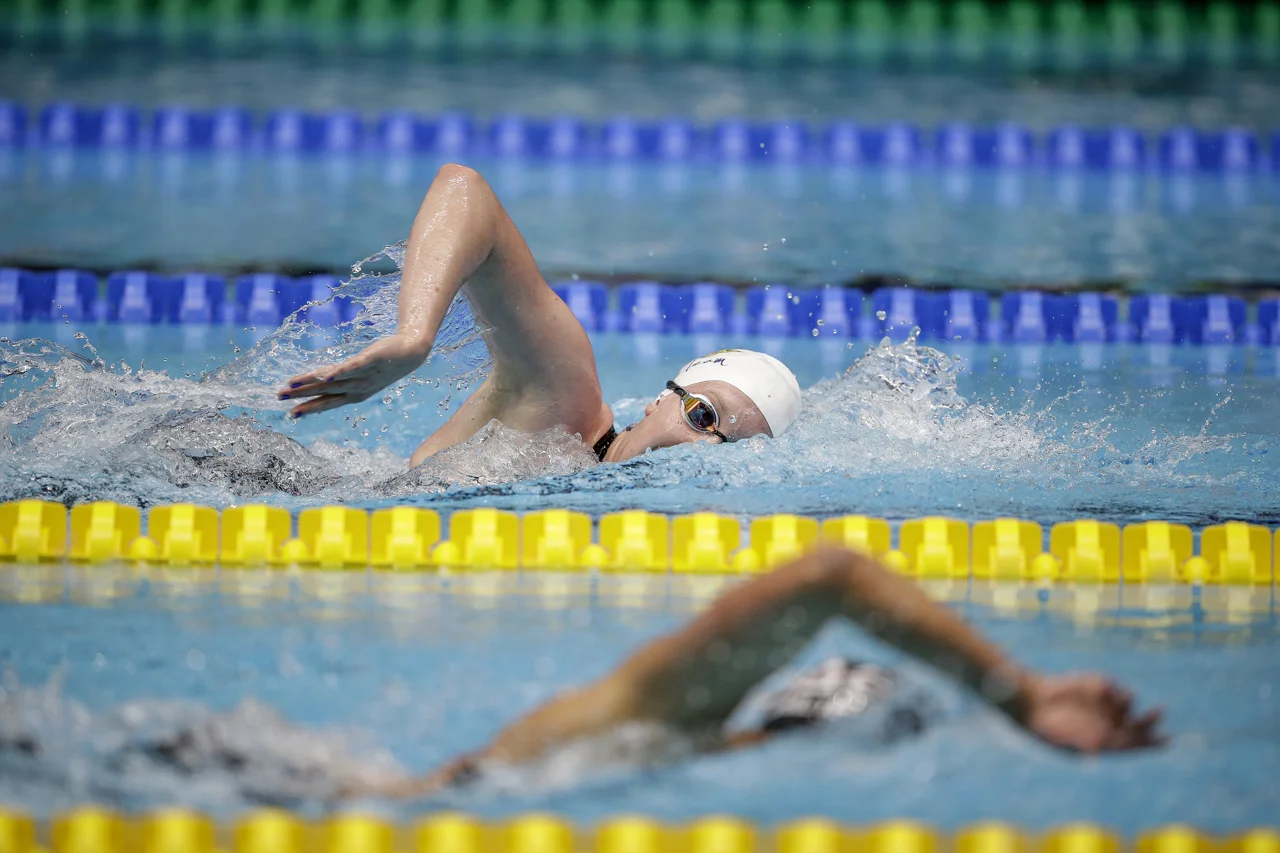Club Wolverine's Sierra Schmidt chases down Texas A&M's Joy Field during the 1500-meter freestyle race at the Phillips 66 National Championships at IUPUI Natatorium in Indianapolis on Saturday, July 1, 2017. Schmidt finished fourth overall with a time of 16:19.59.