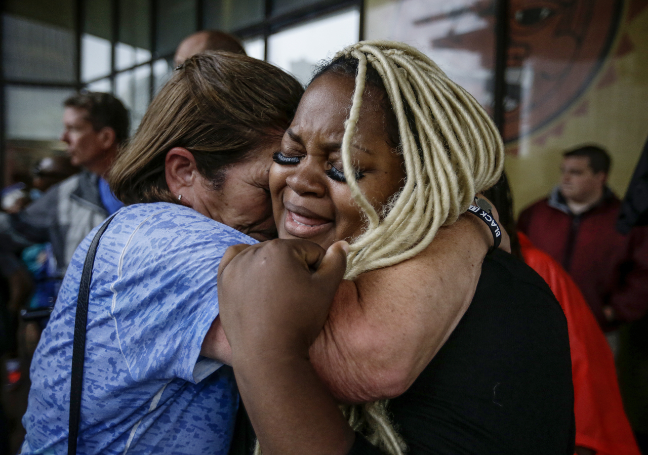 Peggy Meyer (left) consoles Ashley Thomas (right) at the Justice for Aaron Bailey rally at City Market on Friday, June 30, 2017. "If I don't do something about this injustice now, how will I better my sons' futures?" says Thomas.